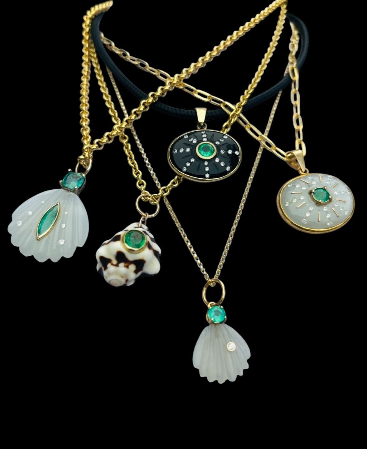 Natural Shell Pendant

Natural Shell, Emerald, 14k Gold

This shell has deep brown coloring which looks so pretty against the beautiful oval center emerald bezeled in gold.  

This one-of-a-kind pendant measures 3/4” in length excluding the gold