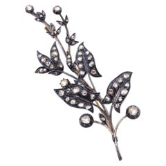 Large diamond branch brooch in 18 karat gold and silver