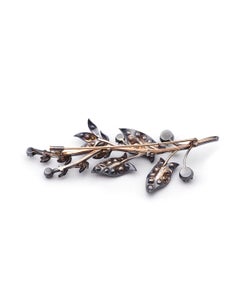Large diamond branch brooch in 18 karat gold and silver