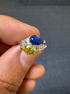 Vintage Platinum Fancy Intense Yellow Diamond Sapphire and Baguette Diamond Ring