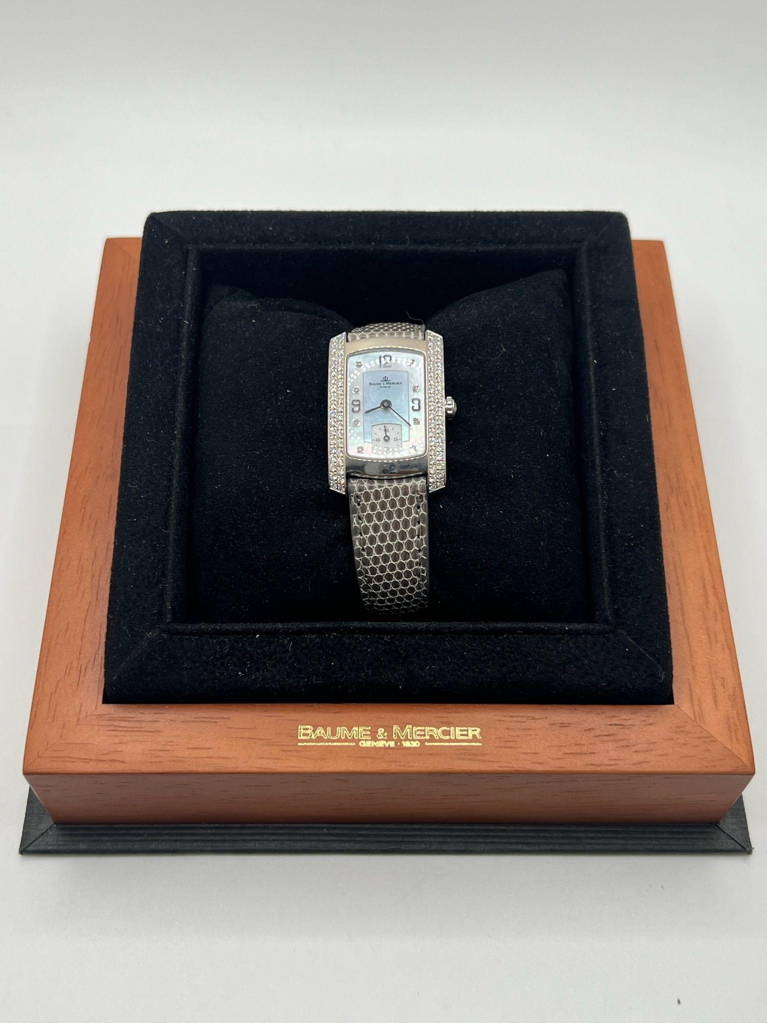 The Baume & Mercier Hampton Milleis is a stunning example of timeless elegance and refined Swiss craftsmanship. This iconic model features a rectangular 18K white gold case beautifully adorned with a delicate diamond setting, adding a luxurious