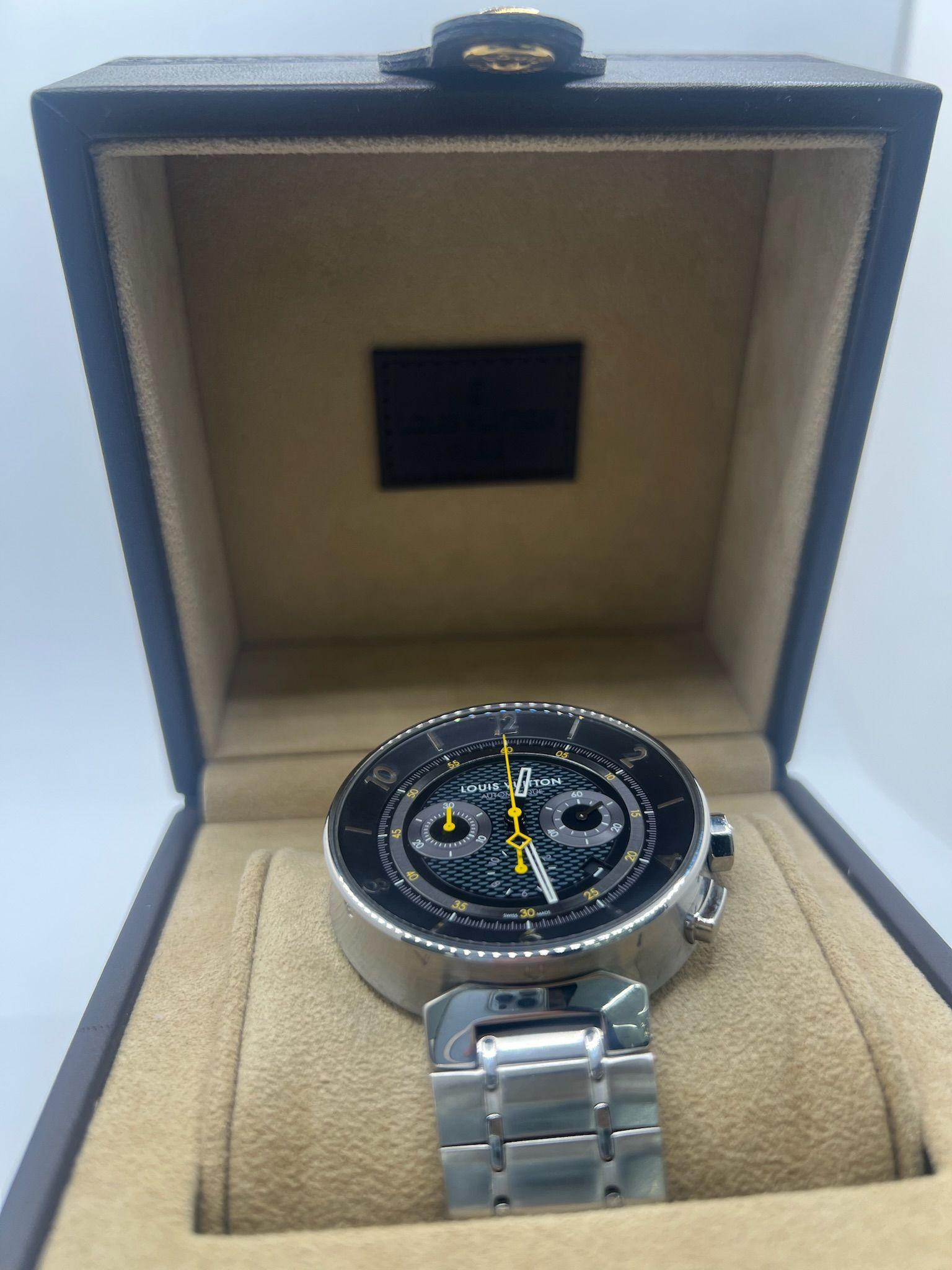 This Louis Vuitton Tambour Chronograph Q8D40 combines refined watchmaking with the bold, modern aesthetic of the Maison. Crafted in stainless steel, the robust 44mm case showcases the distinctive Tambour silhouette, while the deep black dial