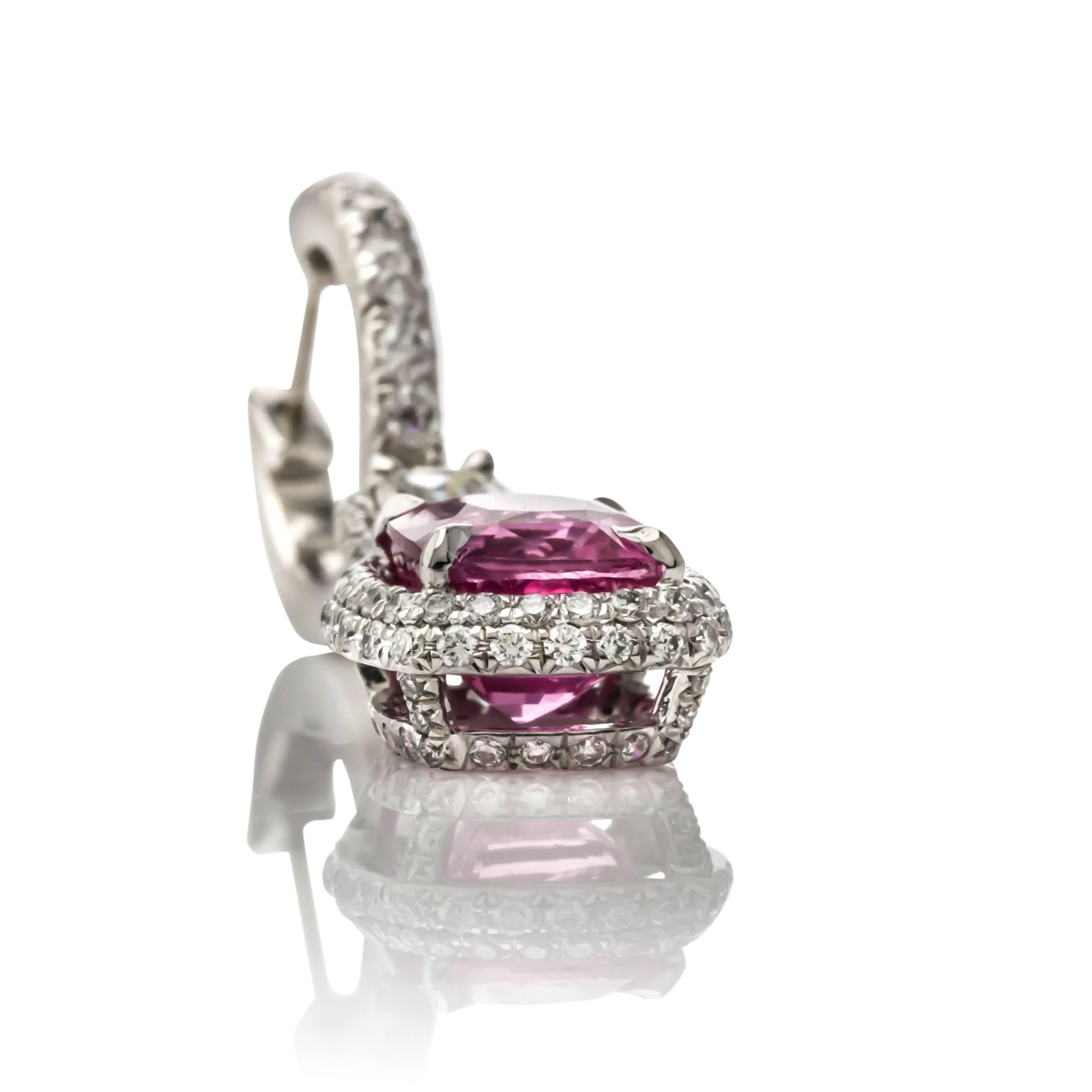One of a kind 18K white gold pink sapphire and diamond drop earrings. Set with two pink sapphires weighing 5.03 carats total weight of fine color and clarity, surrounded by two hundred and four round brilliant cut diamonds weighing 1.02 carats total