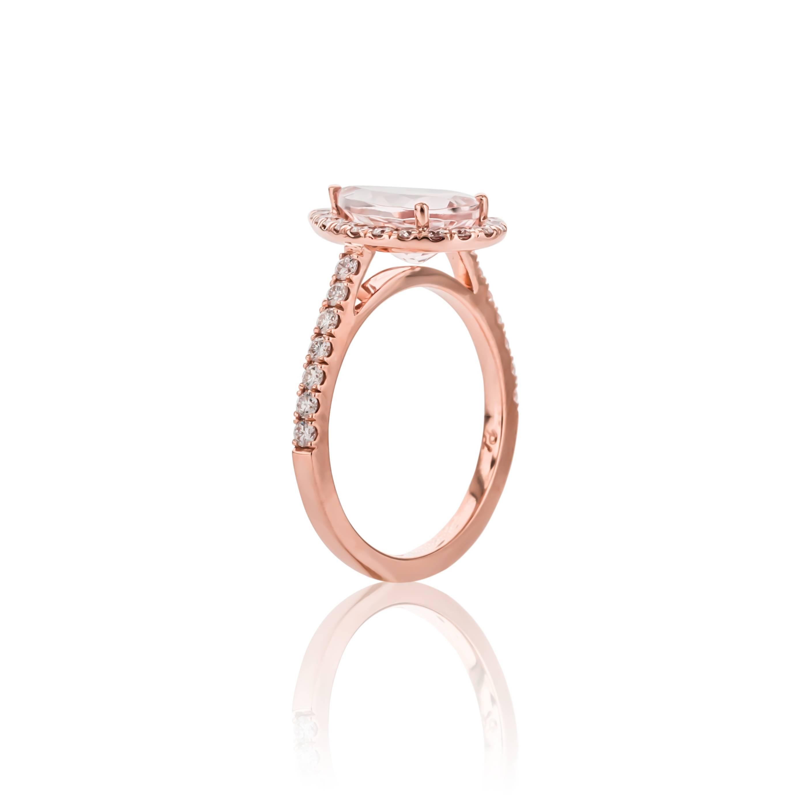 One of kind 18K rose gold morganite and diamond ring. Set with one pear shape morganite weighing 1.95 carats of fine color and clarity, surrounded by round brilliant cut diamonds weighing .57 carats total weight, G color and VS clarity. 