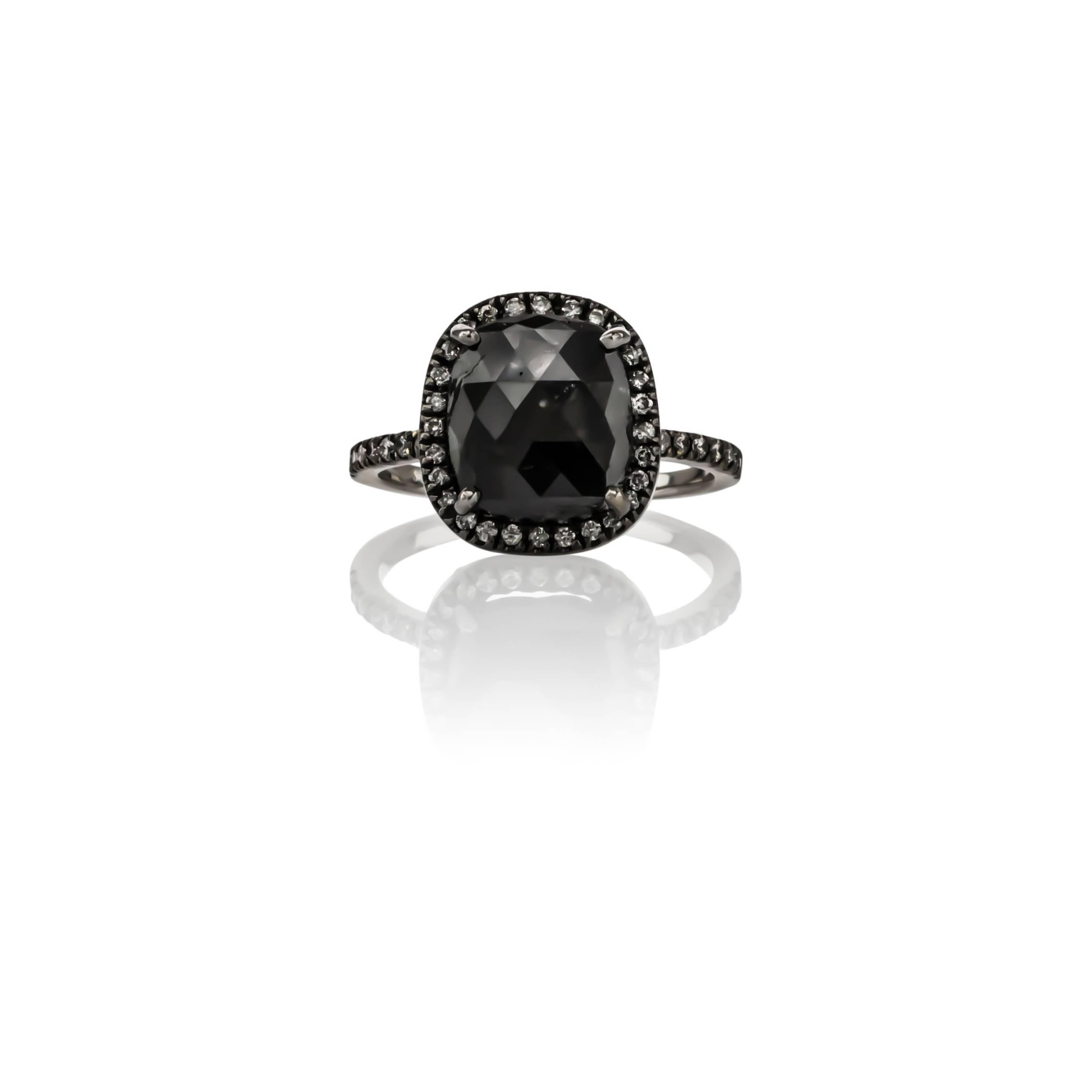 18K white gold black diamond halo ring, by Sethi Couture. Set with one cushion cut black diamond weighing 4.46 carats, surrounded by round diamonds weighing .35 carats total weight.

Finger size 6.50, can be re-sized.