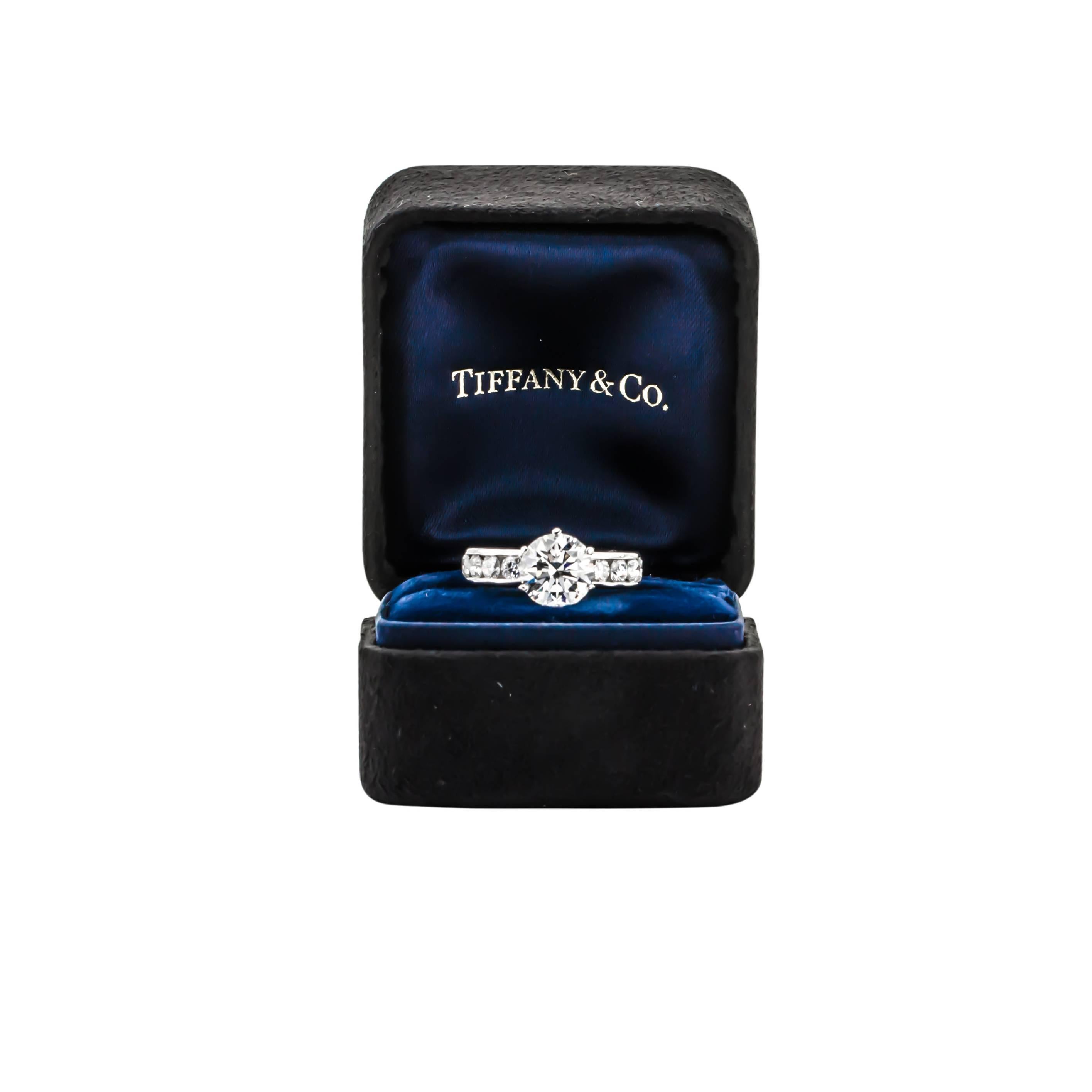 Stunning Tiffany & Co. engagement ring featuring one 2.08 carat round brilliant cut diamond with H color and VS1 clarity.  The ring is also set with eight round brilliant cut diamonds equaling .72 carats. 

This beautiful platinum ring is a size