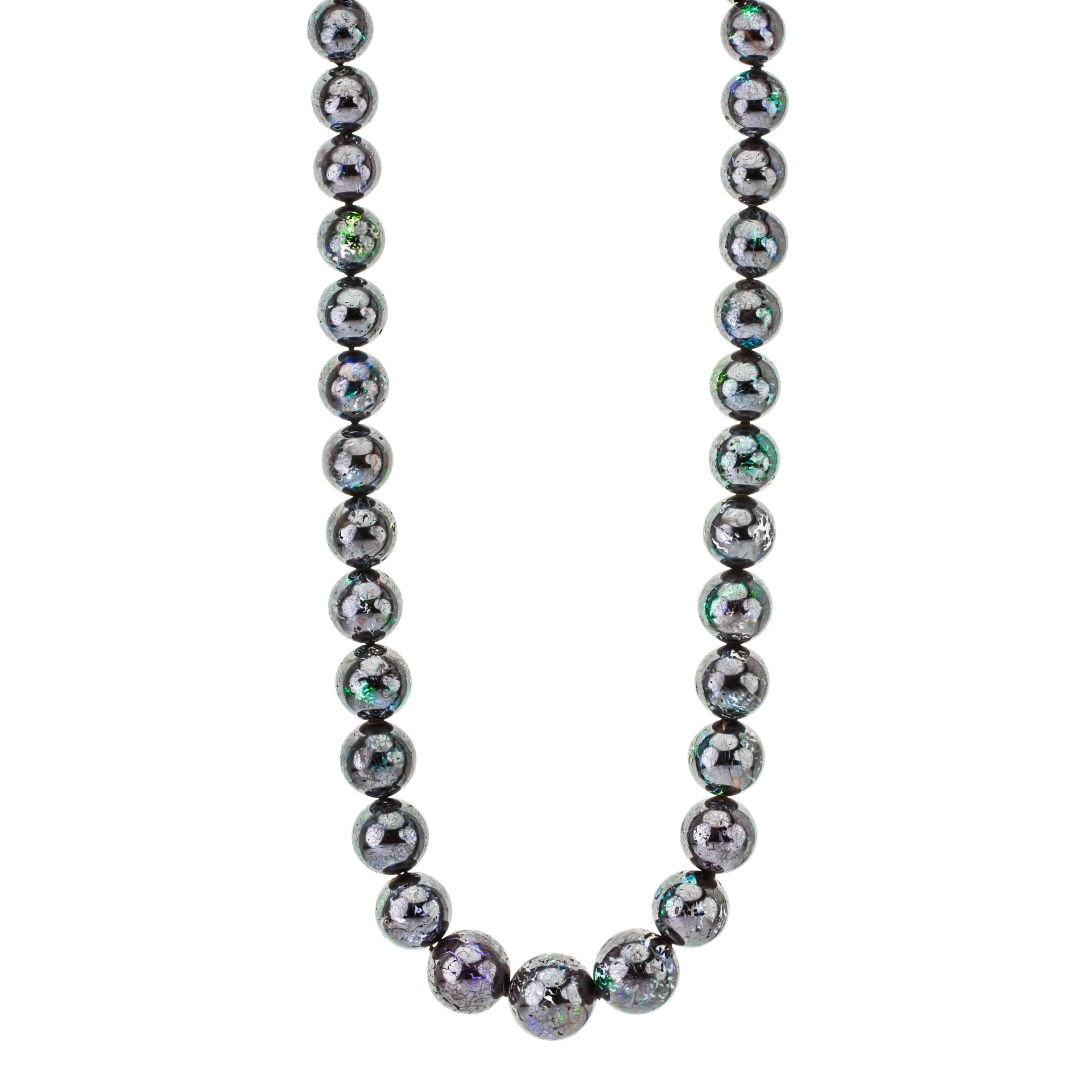 This unique design opal necklace showcases 35 boulder opals. Hand-crafted in 14K white gold. Handmade in Richardson, TX.