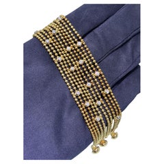 Bracelet « Draperie de Décolleté » de Cartier, en or jaune 18 carats, orné de perles et de maillons multiples, serti de diamants