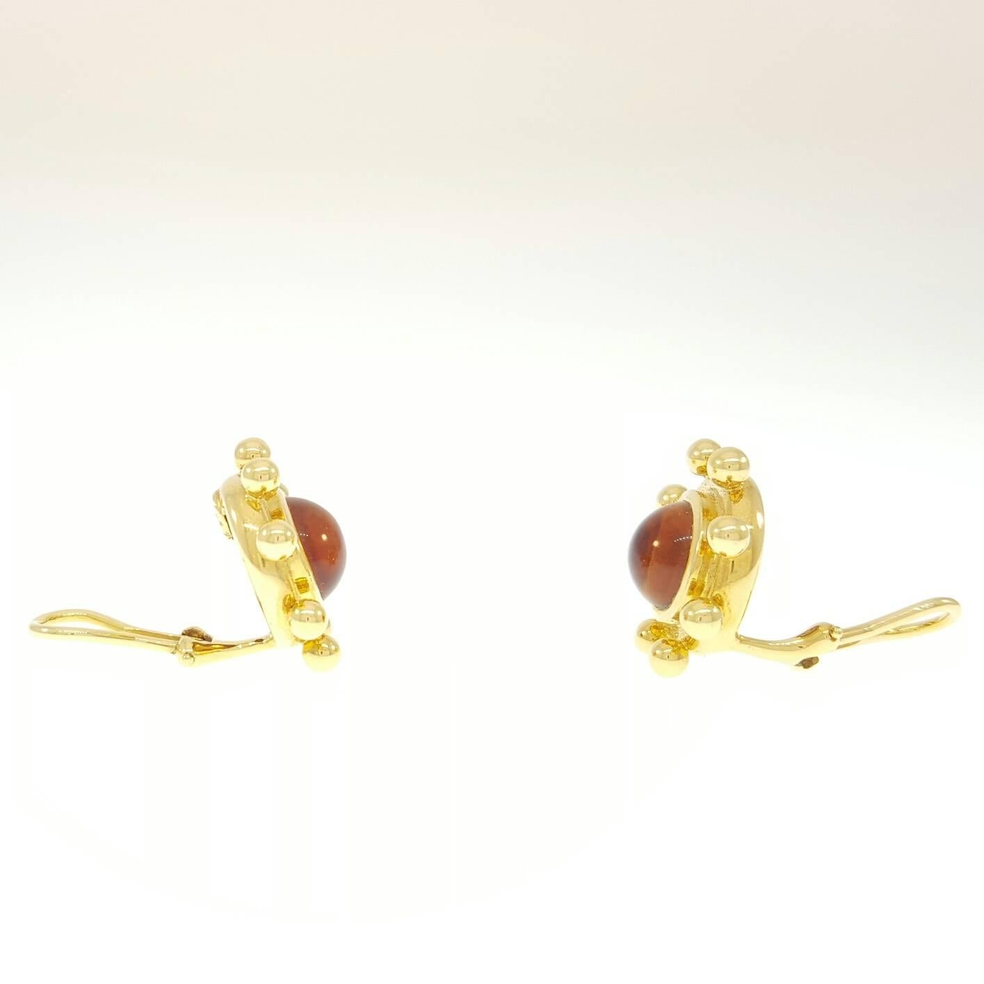 18 Karat yellow Gold and Citrine Earrings, Paloma Picasso designed, Tiffany & Co., each earring is bezel-set with a 9.5mm cabochon-cut citrine. The earrings measure 21mm in length
