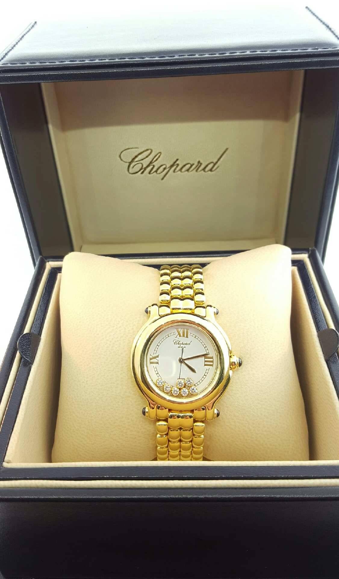 Women's Chopard Gold and Diamond Happy Sport Watch. The watch is 18 karat yellow gold and is engraved on the back 