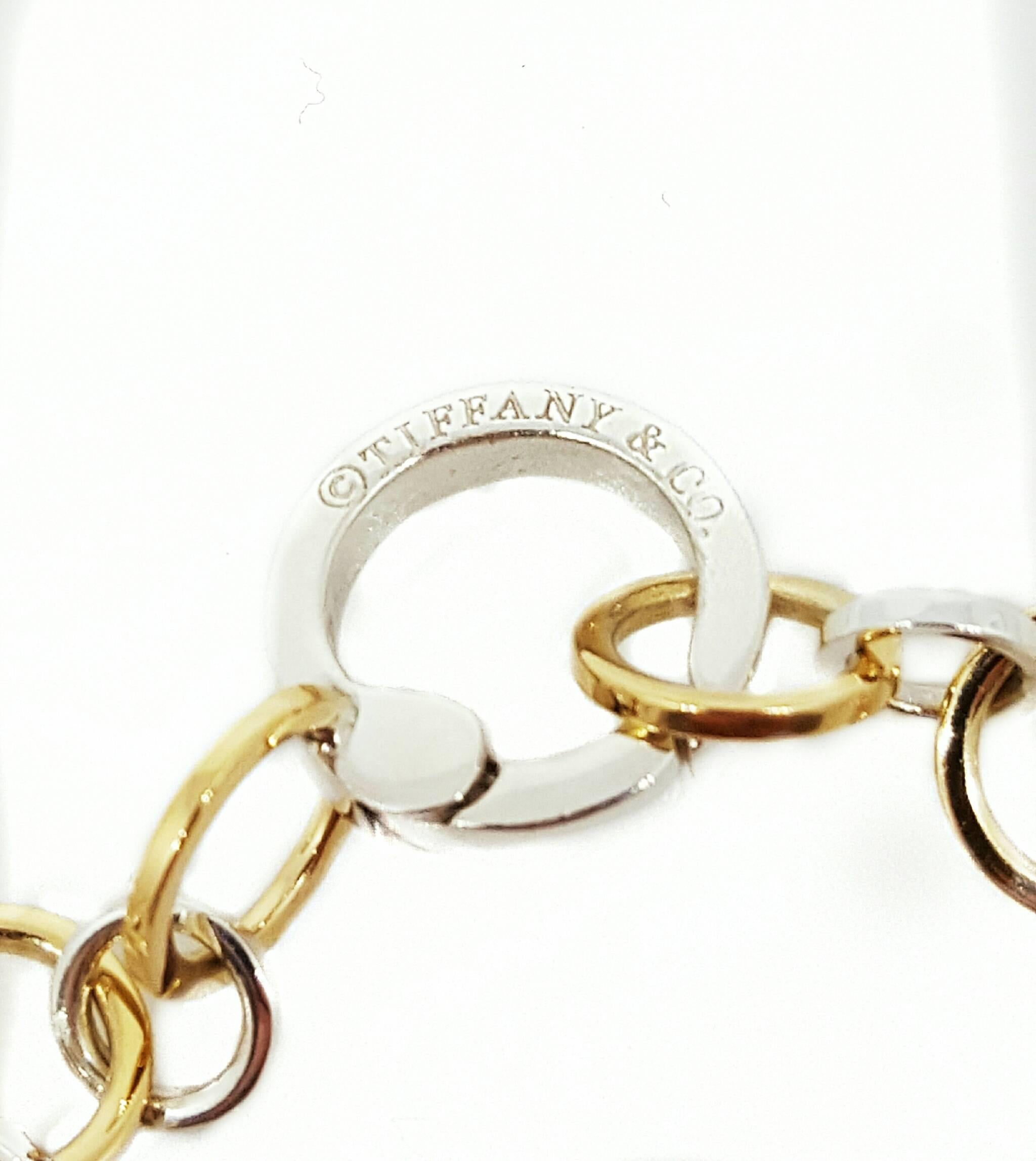 Tiffany & Co. 18 karat yellow gold and sterling silver circle link necklace. The necklace is 18