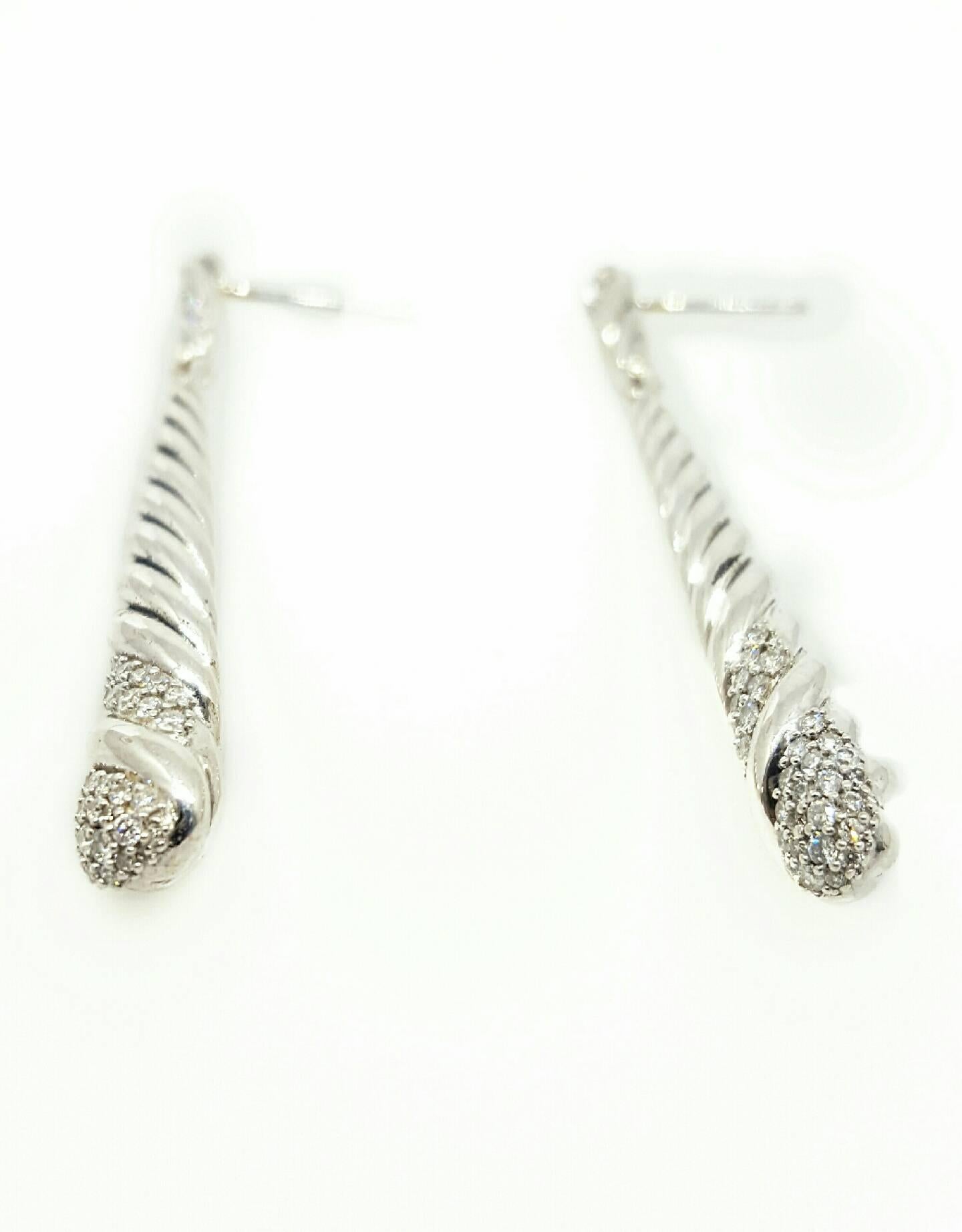 David Yurman Sterling Silver Cable style earrings featuring pave set diamonds. The diamonds have a total weight of 0.44cttw. The earrings are 48mm long and feature friction back posts. Both earrings and backs are stamped sterling silver and DY