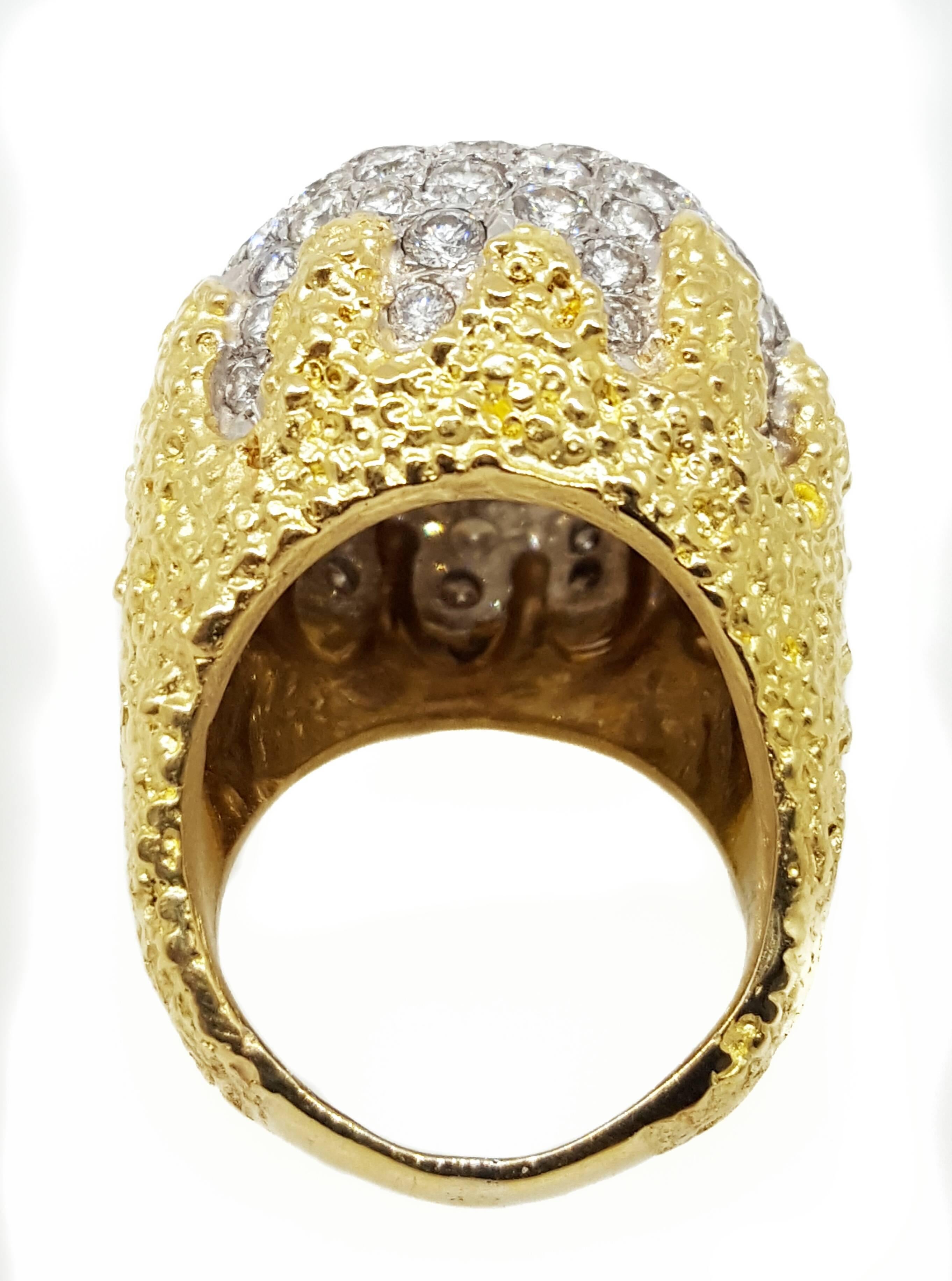 A large diamond dome ring made in the mid 20th century by an unknown designer. The ring consists of round brilliant cut diamonds that weigh exactly 5.62 carats total weight and are H color, VS2 to SI1 clarity. The ring is made out of 18 karat yellow