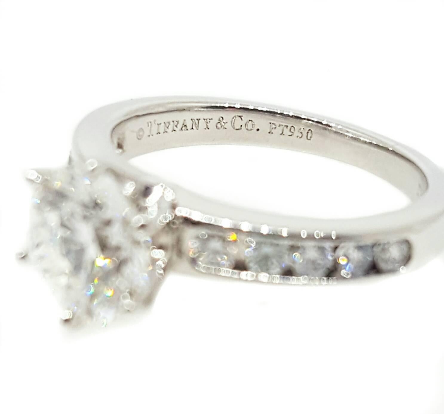 A stunning platinum engagement ring, made by Tiffany & Co., set with a 1.50ct  Round Brilliant cut diamond. The center diamond is GIA certified G color VS1 clarity.  In addition to the center stone, there are 10 round brilliant cut diamonds that