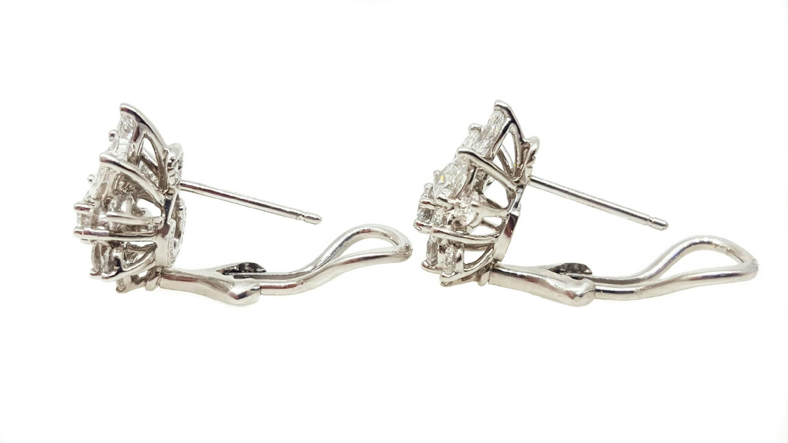 A wonderful pair of Tiffany & Co. Platinum cluster design earrings set with 2.50cttw of diamonds. The diamonds are all F to G color with VVS2 clarity. There are 3 Pear shaped diamonds and 10 Round Brilliant cut diamonds in each earring. The