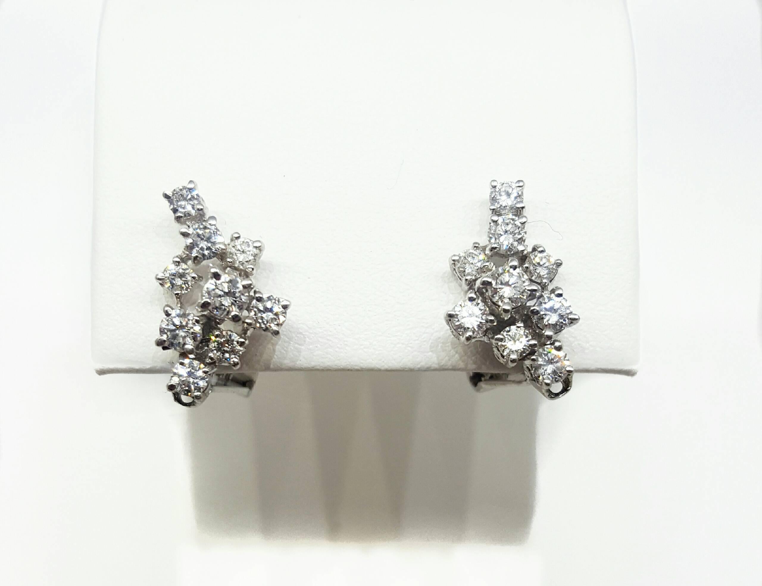 A unique pair of 18 karat white gold detachable diamond dangle earrings. The earrings are set with approximately 2.00cttw of Round Brilliant cut diamonds. The earrings can be worn as a dangle style earring, or adjusted to be worn as a cluster style.