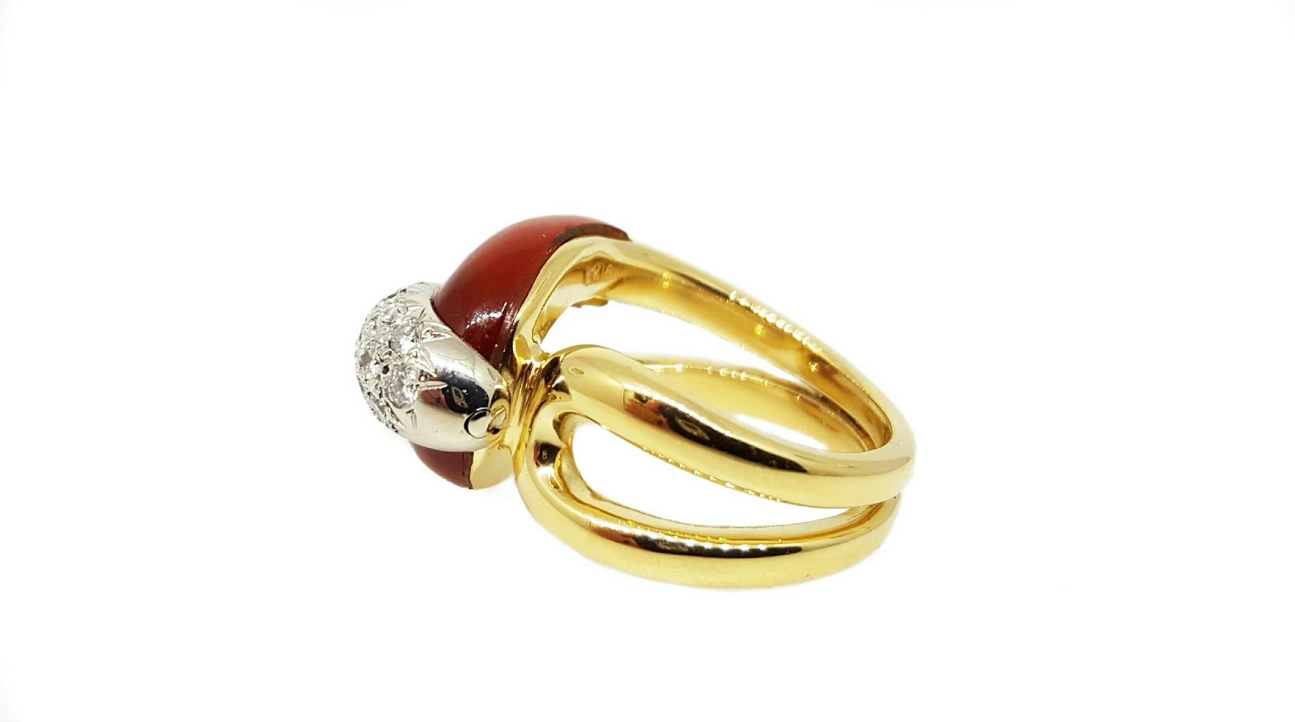 An 18 karat yellow gold ring inlaid with carnelian and bead set with round brilliant cut diamonds. There are a total of 16  diamonds that weigh approximately 0.45cttw. The ring is a 5.5 and can be resized.

A ring like this is hard to find in such