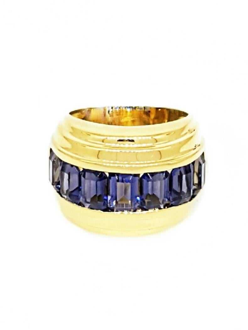 An early example of David Yurman's work. A large gold ring incorporating 7 individual tanzanite stones that are channel set in the band. Being an early piece from David Yurman, this ring has a unique look to it that sets it apart from other Yurman