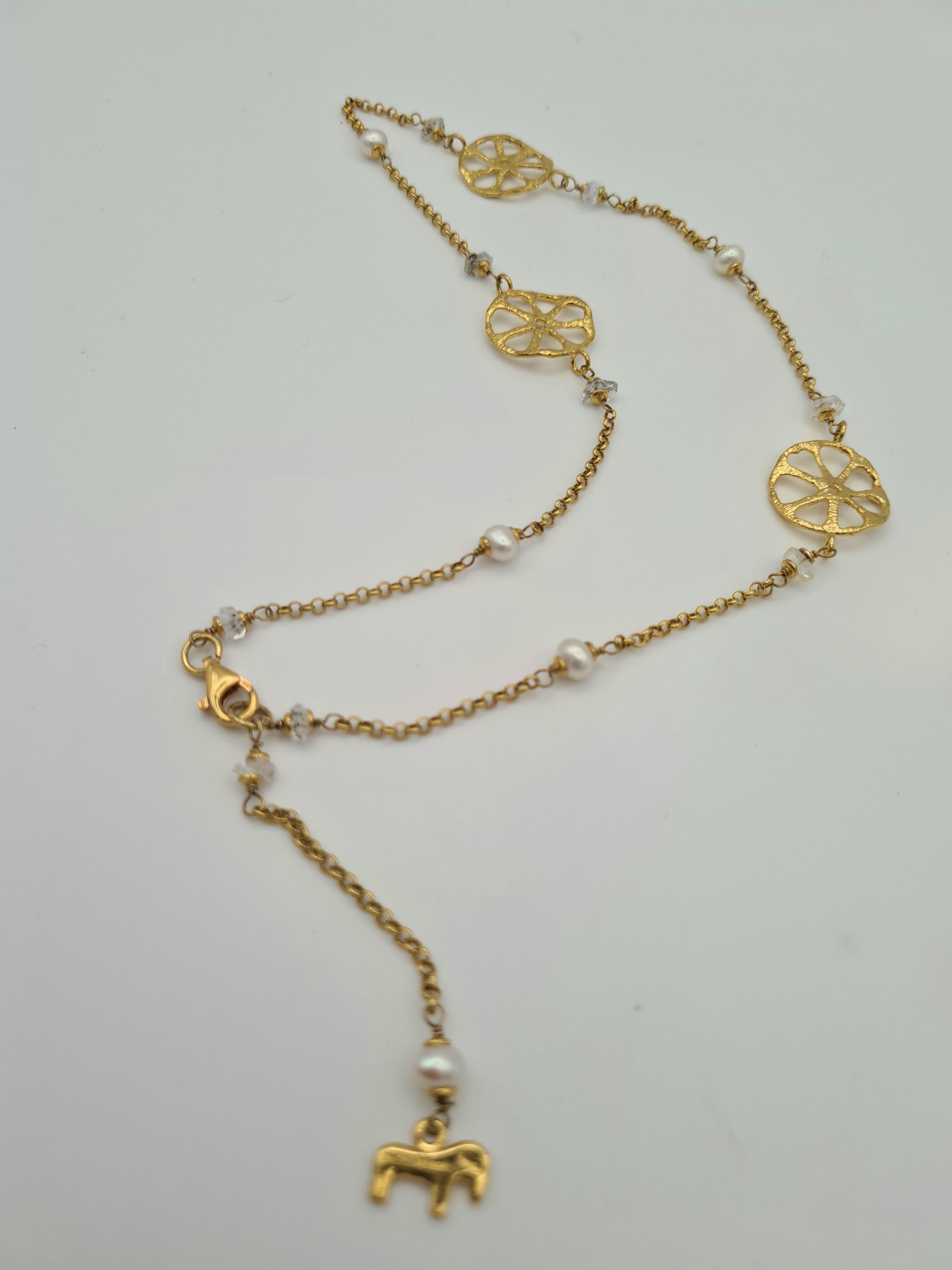 Girocollo Disco Traforato, realizzato a mano con l'antica tecnica della Cera Persa o microfusione, in Argento 925 placcato in Oro 24 carati; arricchito da perle d'acqua dolce e Diamantino di Herkimer.
Questo girocollo è ispirato ad un piccolo Disco