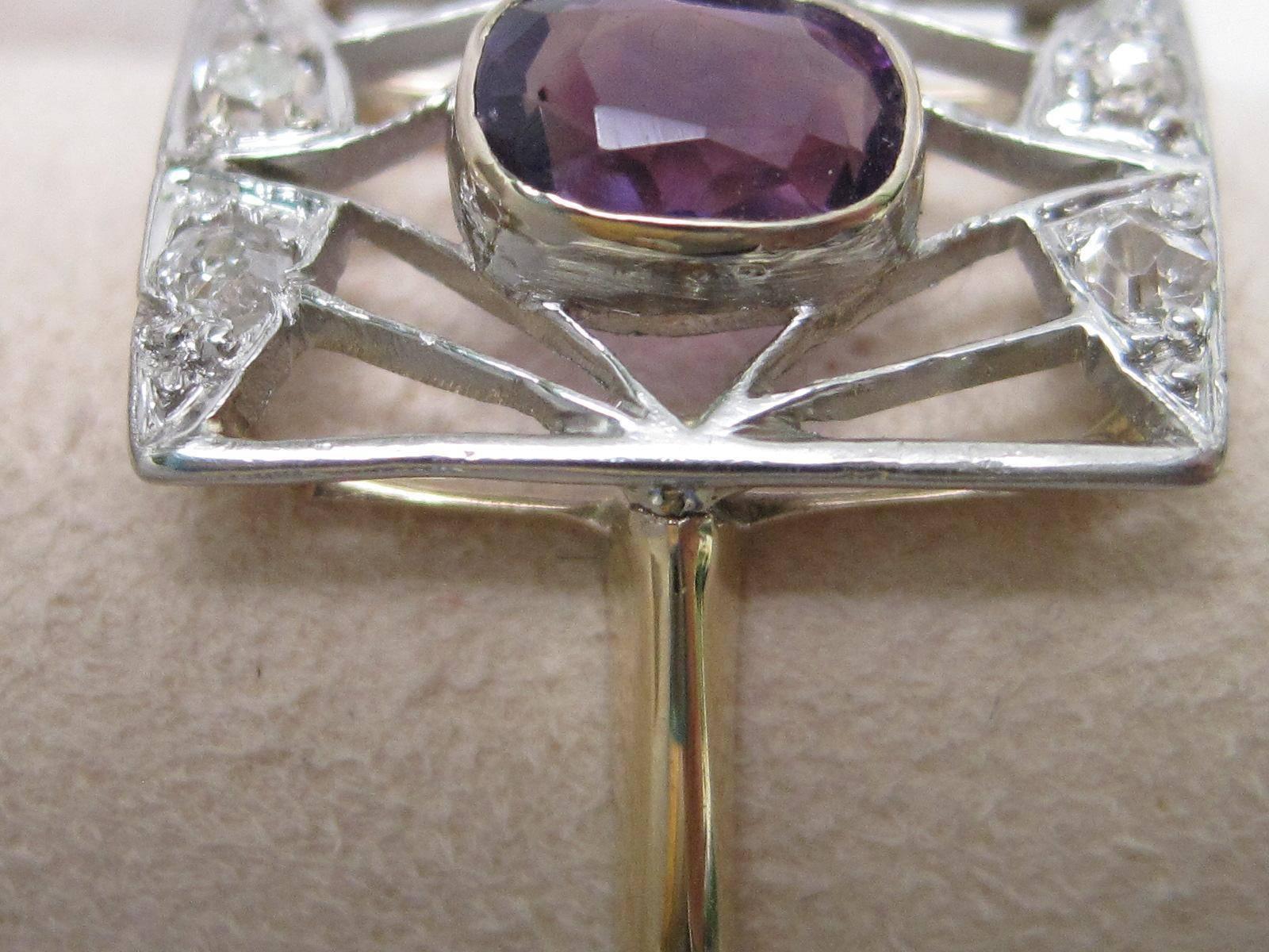 This circa 1910 Edwardian ring features a beautiful center amethyst and four old mine cut diamonds, all set in platinum over gold.

The light and dainty construction makes a perfect ring for the women searching for a right hand ring, or birthstone