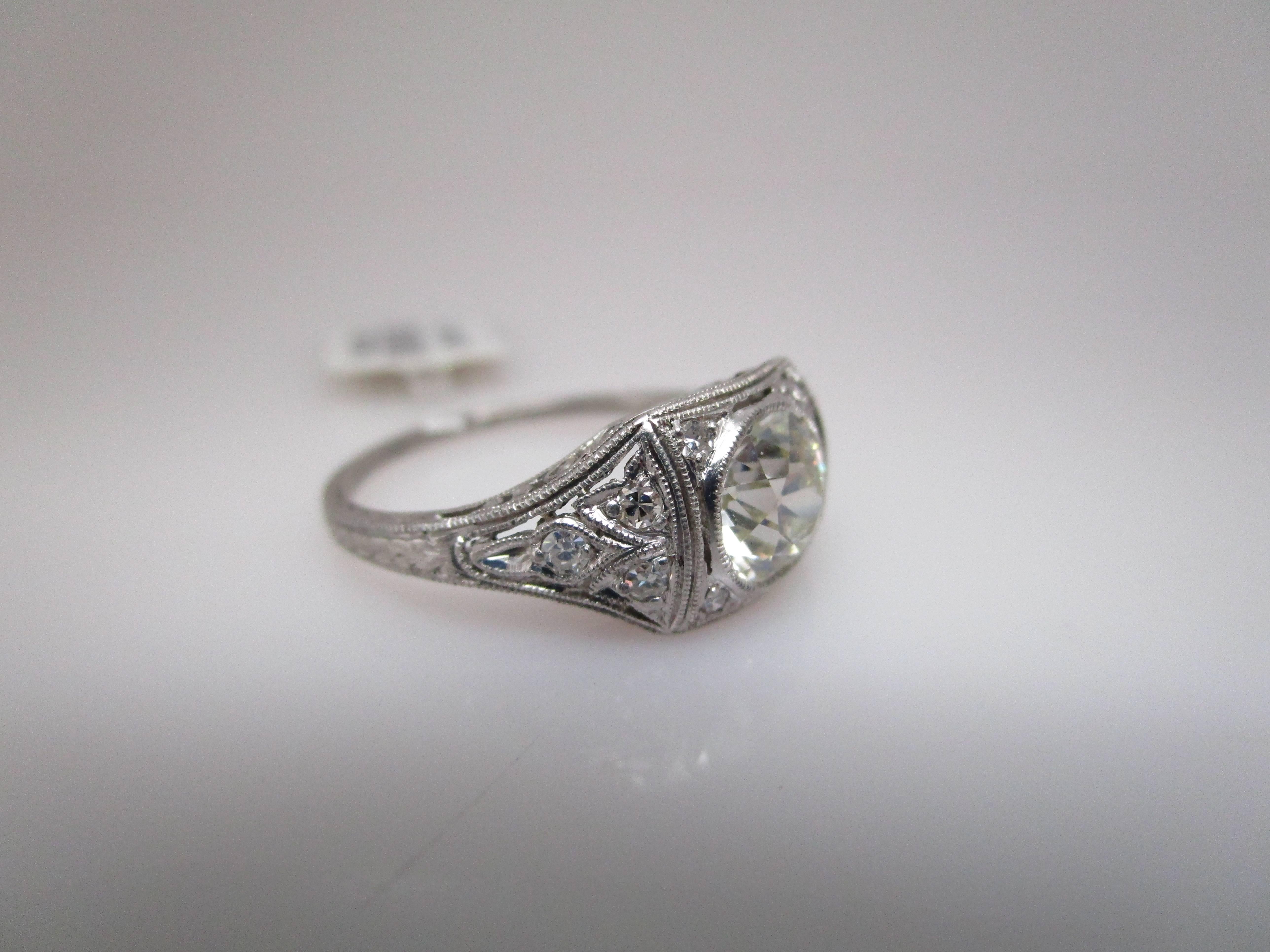Diamond: 1.07ct K VS Old Euro Cut round with GIA report
Set in c. 1910-1915 Platinum Edwardian ring with approximately 0.14 carats total of melee diamonds.
Lovely milgrain bezel around center diamond. Easy to wear as the ring sits low to