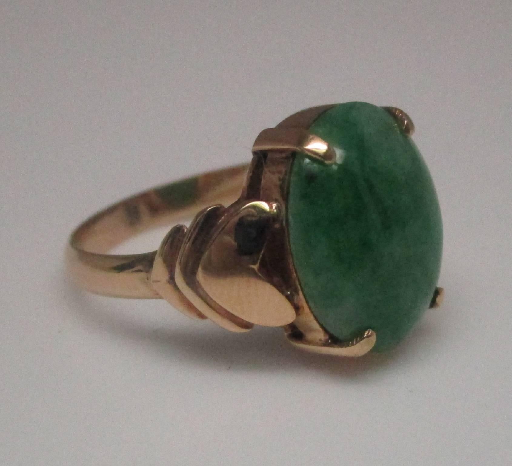 Jade always makes a statement for the most discerning. The beautiful polish allows this gem to truly glow and the 18 karat yellow gold makes it very wearable, stepping smoothly from the stone to the shoulders. It lays close to the hand, making it