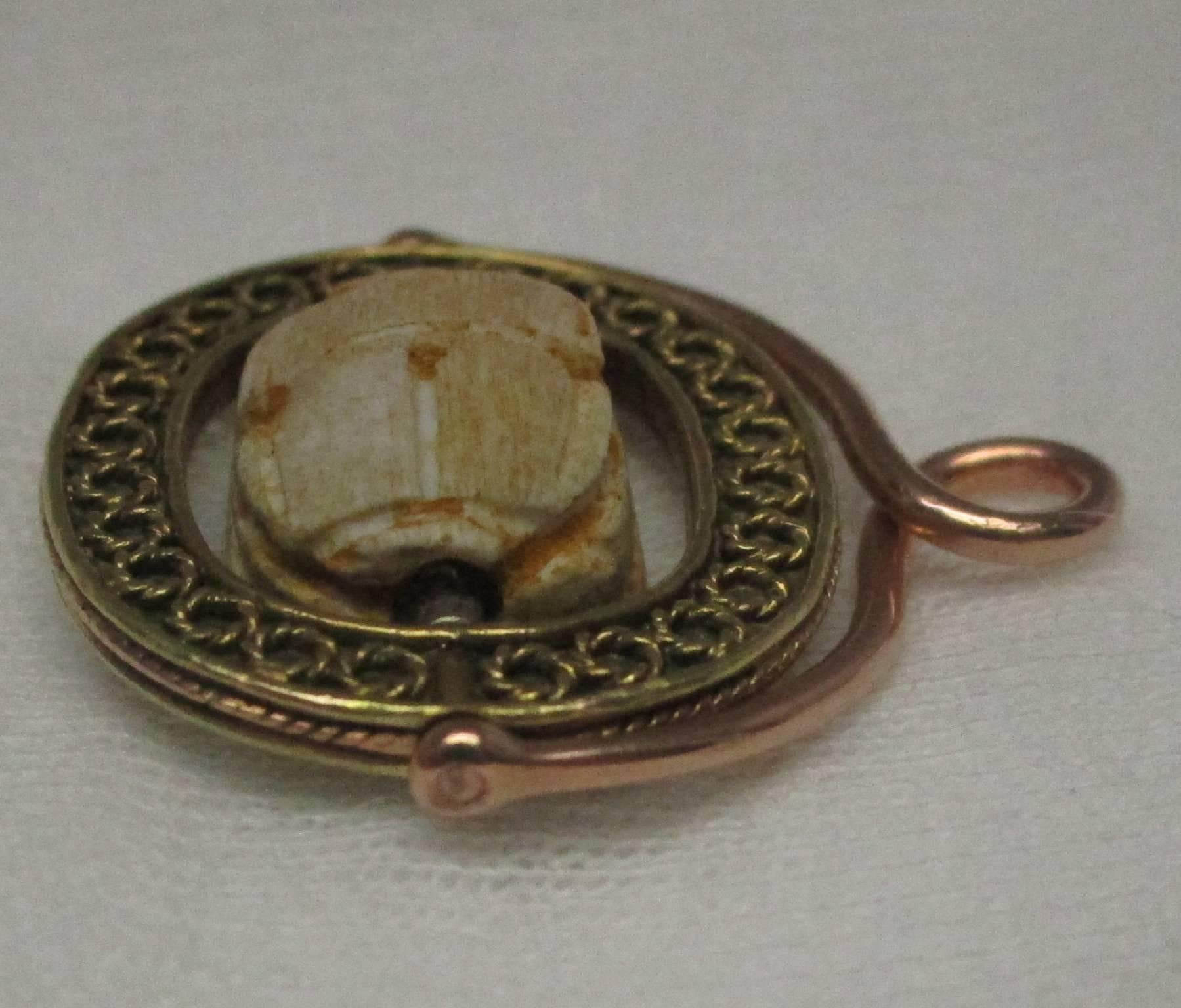 This fob beautifully demonstrates the detail granulation indicative of the overall Etruscan Revival. It features an Egyptian scarab, a common motif cross over from Egyptian Revival. You would be hard pressed to find another fob of this quality.

St.