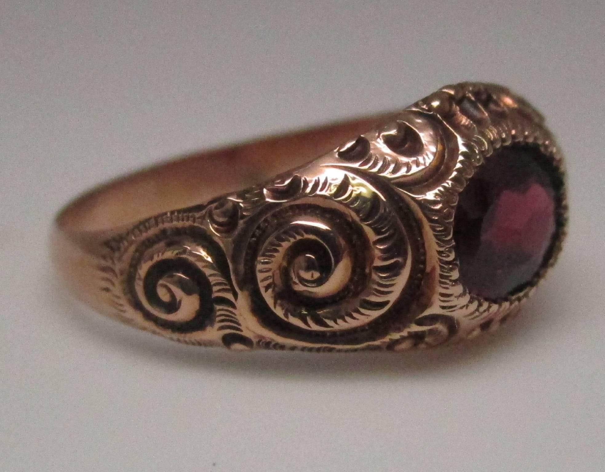 This Victorian ring is truly a stunner. With its deeply etched designs and its lively garnet, you are sure to get noticed. The ring is in exquisite condition, looking as though it was never worn. It is a large ring, being a size 11 ½, but it sits