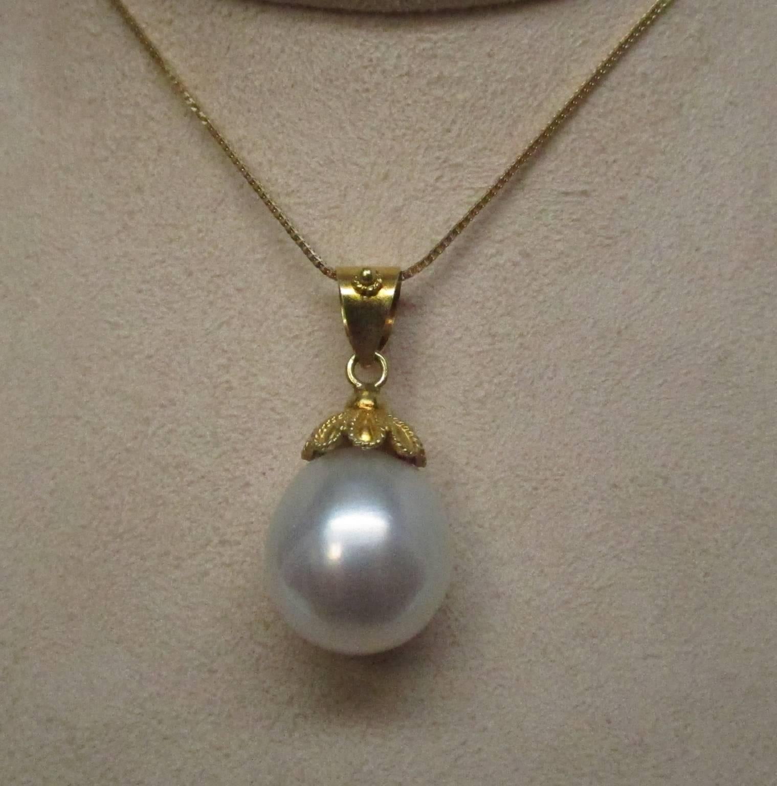 This is a truly impressive South Seas Pearl, 15 x 14 mm, pendant. The cap is 18 karat yellow gold and shows an Etruscan style granular design. It is marked GIKAS. Chain shown is not included, but is available for purchase.

St. John & Myers