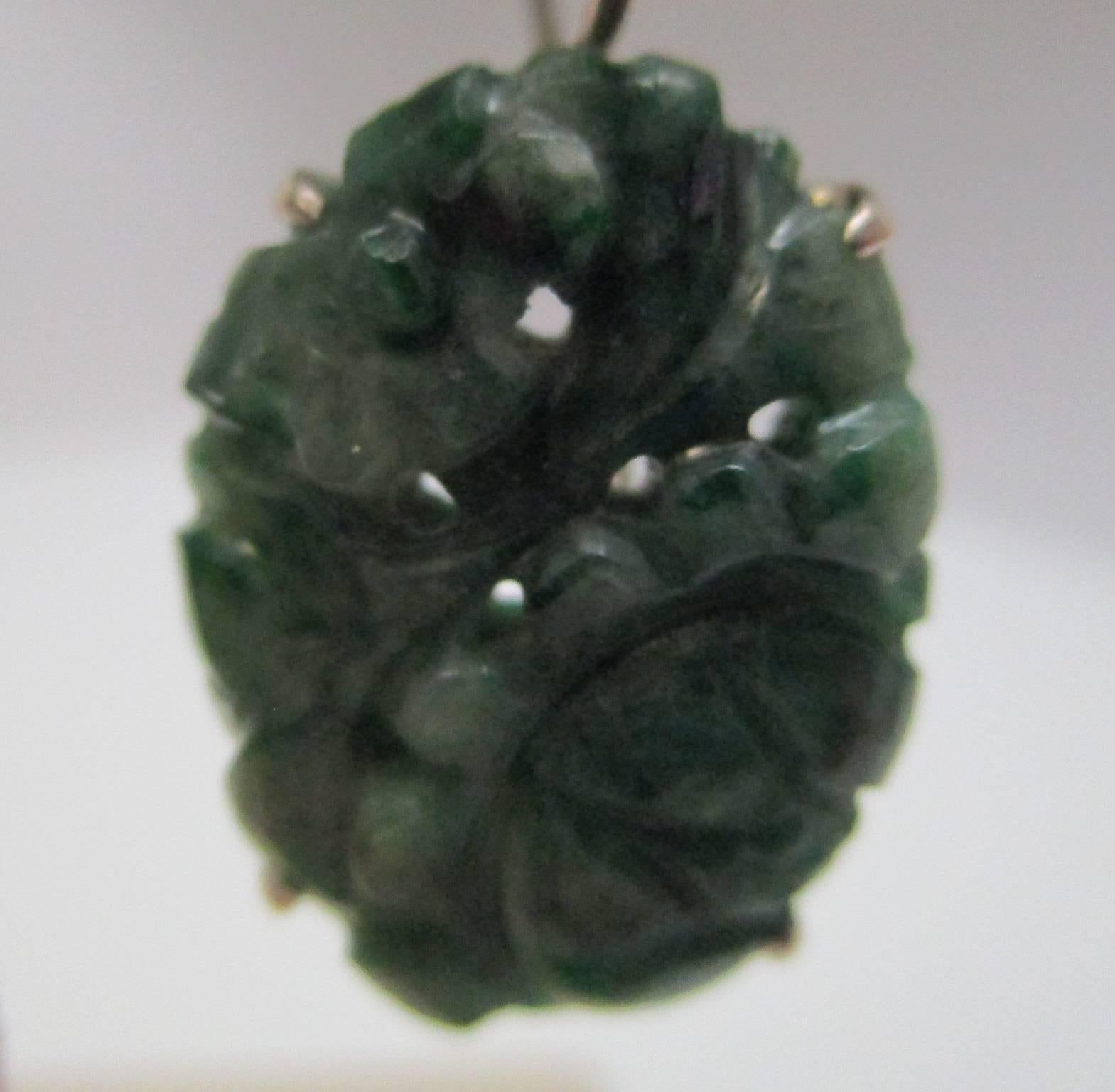These carved nephrite jade earrings have a sterling silver frame and hook. Made in c, 1910, during the Arts & Crafts period, they display lovely pierced carving in a floral motif. You will fall in love with the simple beauty of these