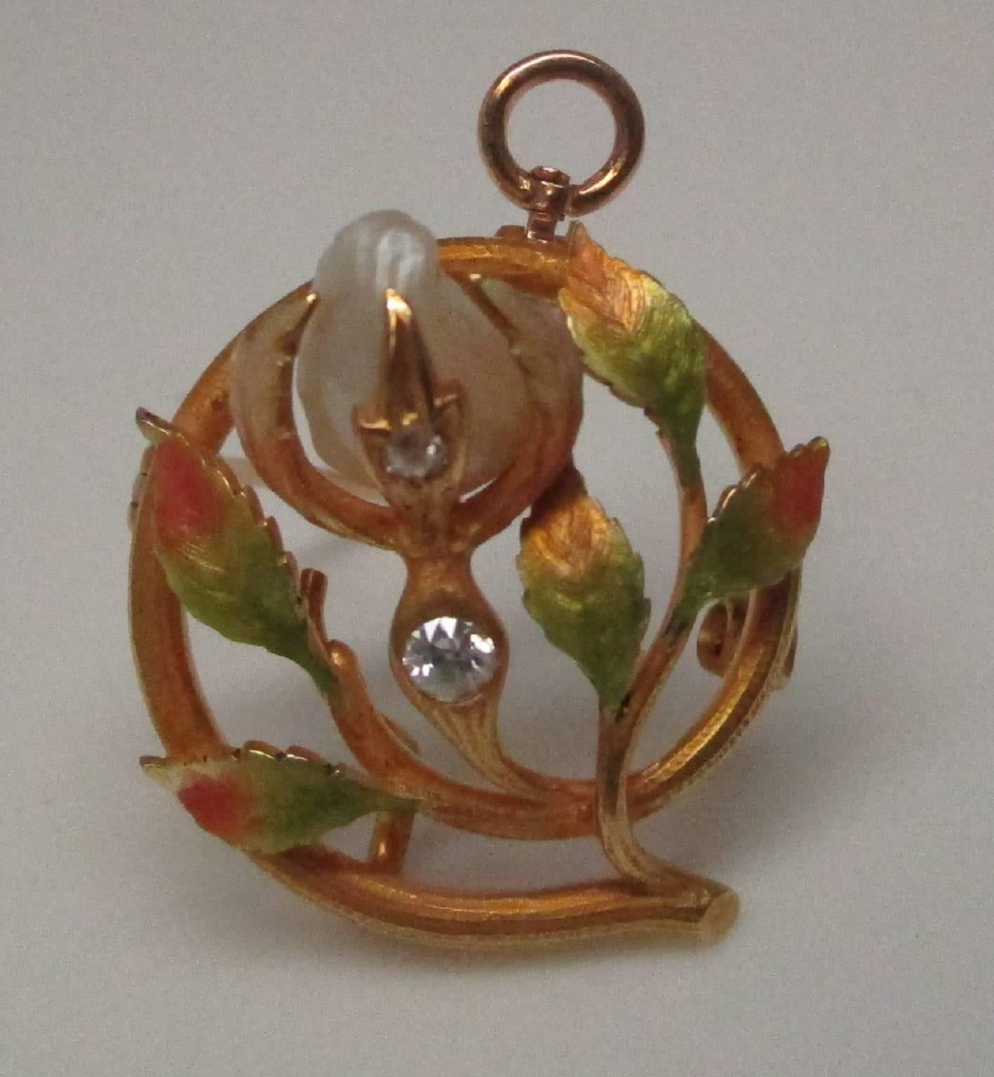 This 14 karat yellow gold pin/pendant is a lovely example of Art Nouveau floral motif. It features two diamonds, 0.05 carat in total, and a natural Mississippi Delta pearl. The Mississippi Delta pearl is not found today due to over fishing. The pin