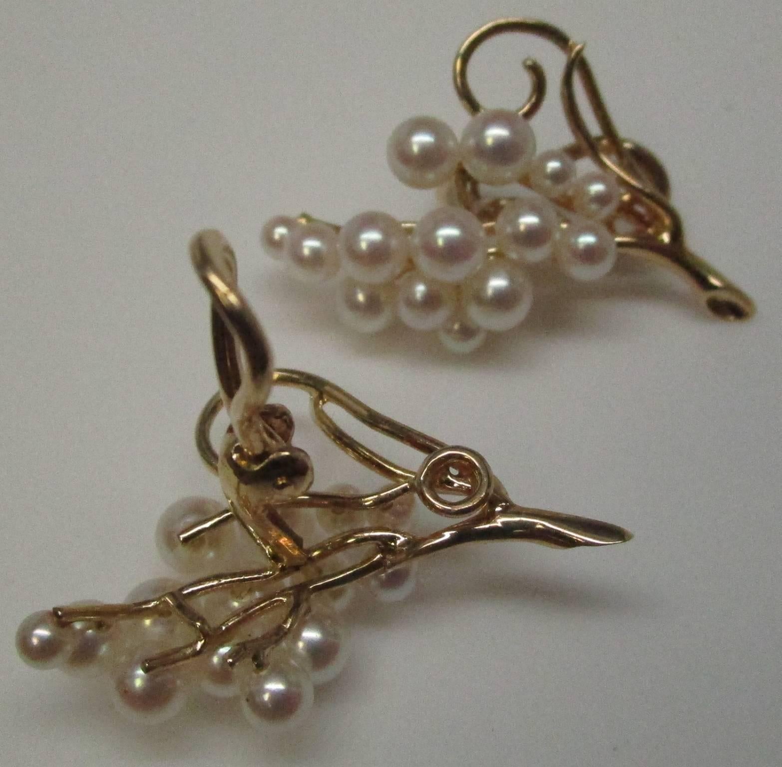 These earrings embody the absolute essence of luxury-- being hand-fed grapes from the vine. The cluster of pearls resembles a bunch of grapes on a 14 karat yellow gold vine. The vine has an elegant swirl that makes them seem lifelike. They are