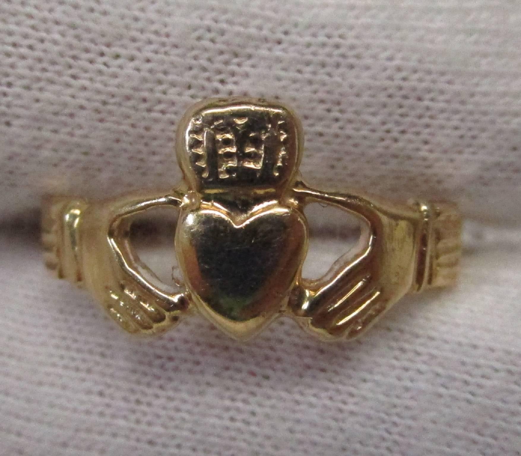 This is a 14 karat Claddagh ring. The Claddagh depicts two hands holding a heart with a crown, symbolizing friendship, loyalty and love. This would be a lovely gift for that special someone. The ring is a size 6.25.

St. John & Myers Jewelry is