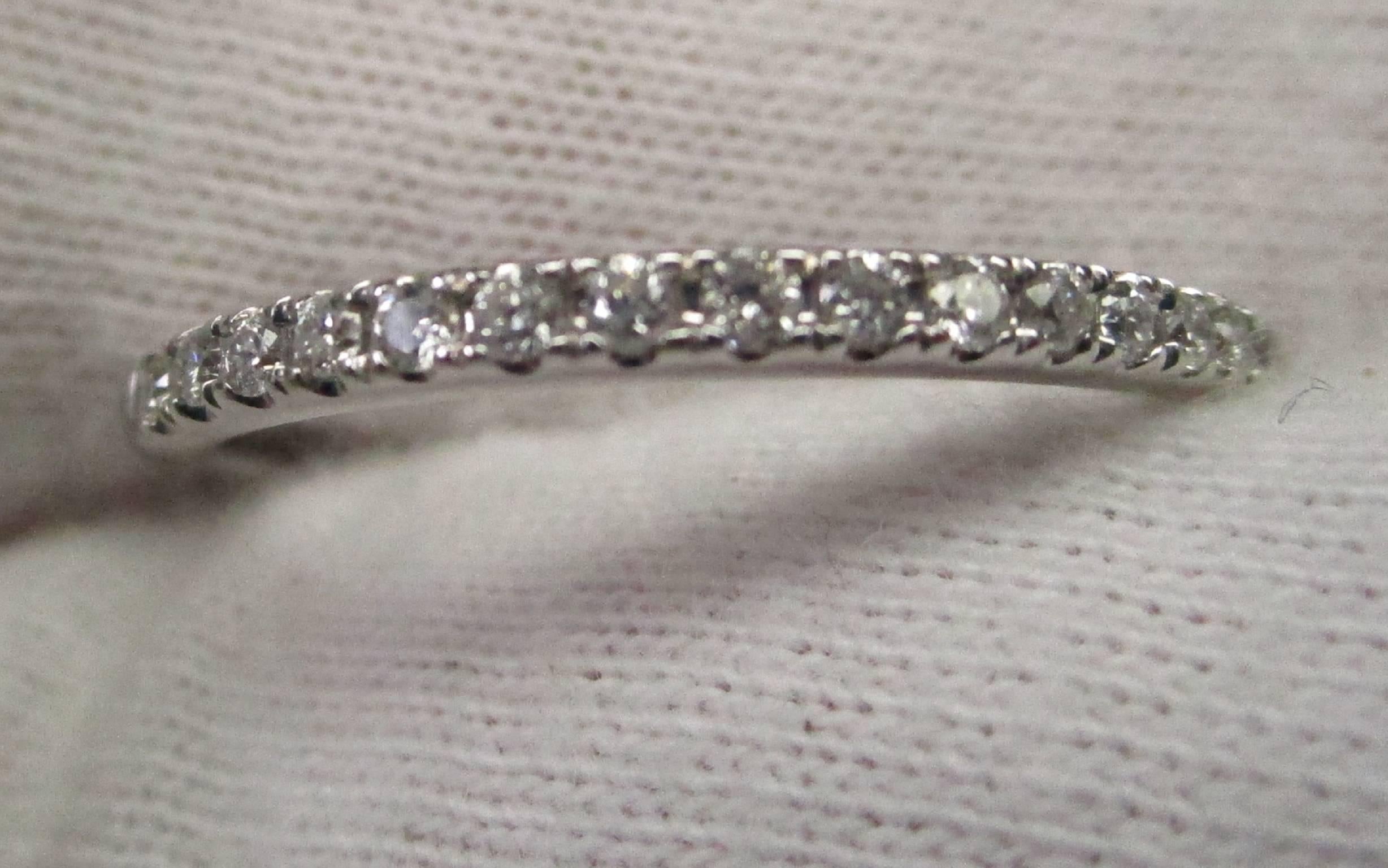 This is a lovely 14 K white gold band with 0.10 carat total weight of round diamonds. This would be a beautiful wedding band or a precious anniversary ring. You can't go wrong with diamonds that are H in color and VS2 in clarity. You would be hard