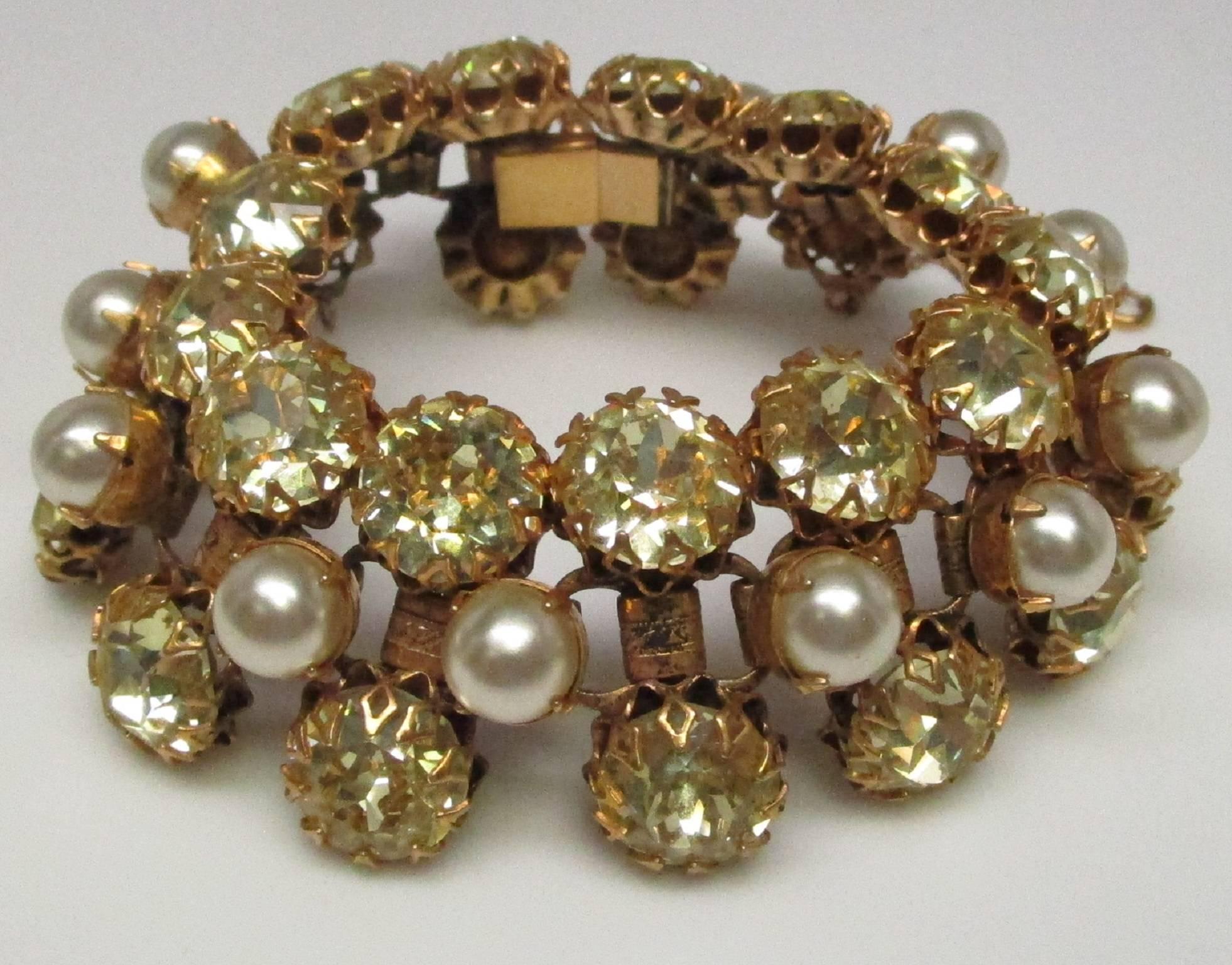 This is a Schreiner of New York bright, beautiful rhinestone and faux pearl bracelet. It was made circa 1940. It is excellent condition with all stones intact. This bracelet Gives you the eye catching look without the worries that would be