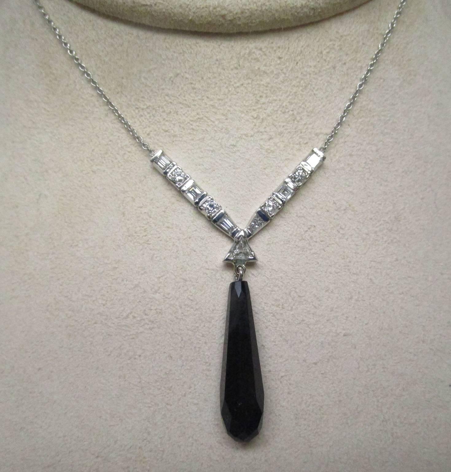 This platinum Art Deco diamond necklace is dazzling. It features four square, rectangular baguettes and four round European cut diamonds. The onyx is articulated. This necklace embodies timeless elegance with the contrast between the square and