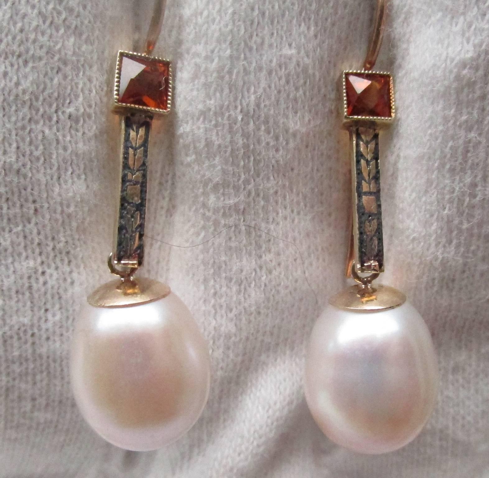 This is a stunning pair of Art Deco drop earrings with vitreous enamel, each graced with a square cut citrine and a large white baroque pearl.  You will not see another pair of earrings like these. They have great movement, but not so much that they