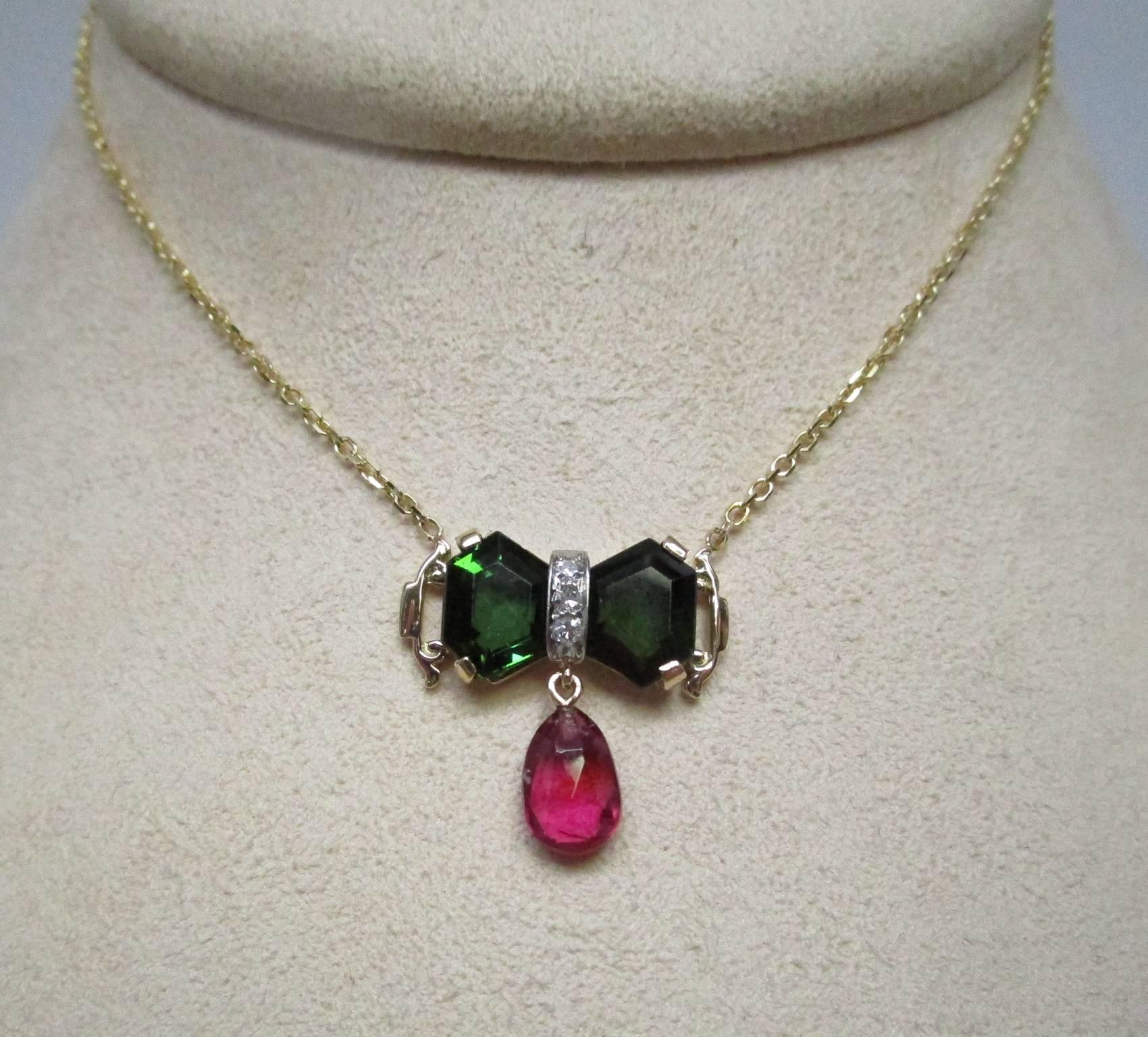 This is a one-of-a-kind 14 karat gold necklace. It has two impressive dark green tourmalines and an eye popping rubelite briolette, not to mention three single cut diamonds. The combination is stunning. This could easiliy become your everyday