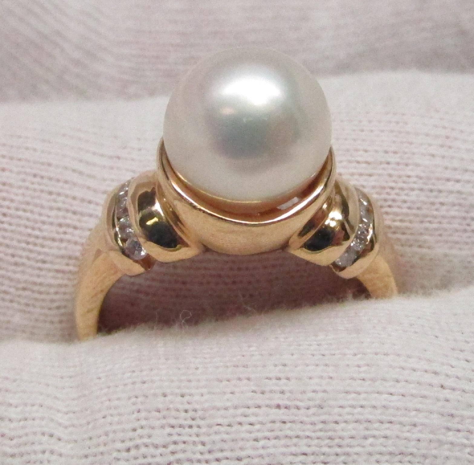 This is a strikingly beautiful cultured pearl set in 14K gold with 0.25ct total weight of diamonds. This ring could be the one that she says 