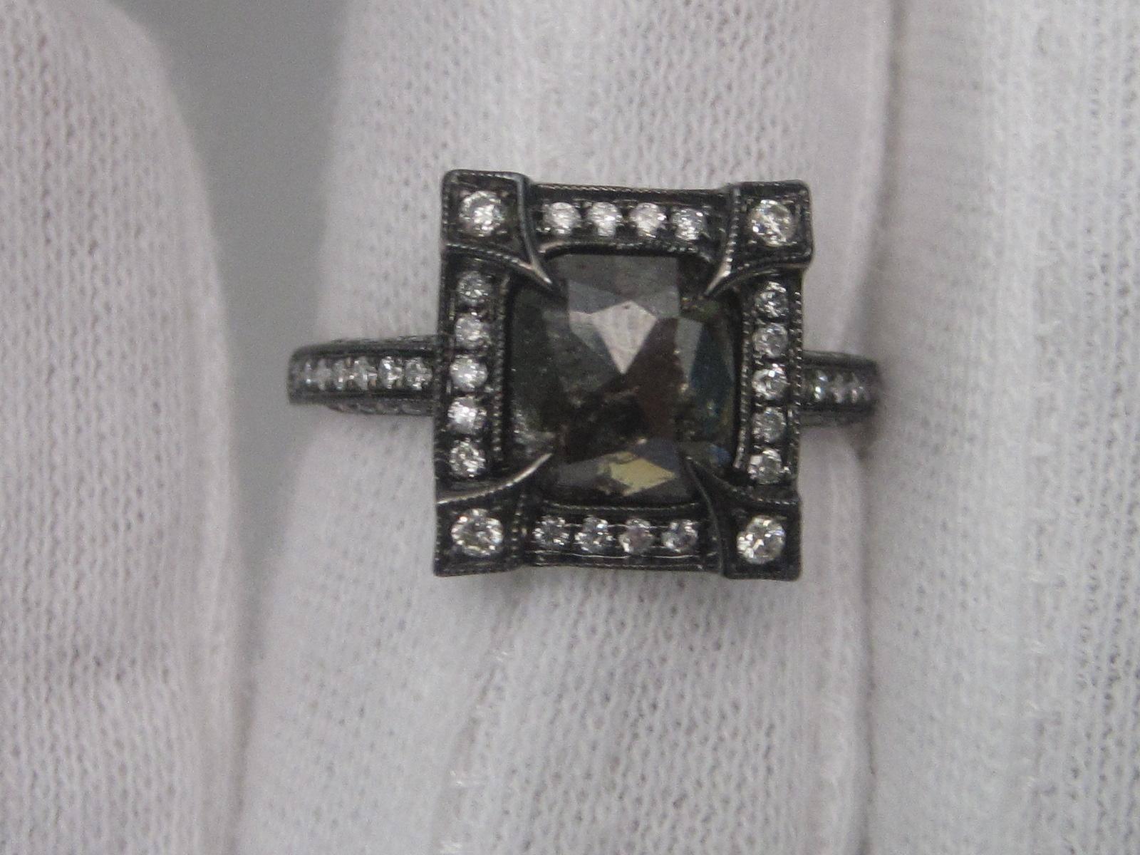 This fantastic 14K white gold ring features a fantastic 1.10 carat black diamond in its center that is completely natural and untreated. The white gold that its set in has black rhodium accents, making it not only stylish, but also unique. On top of