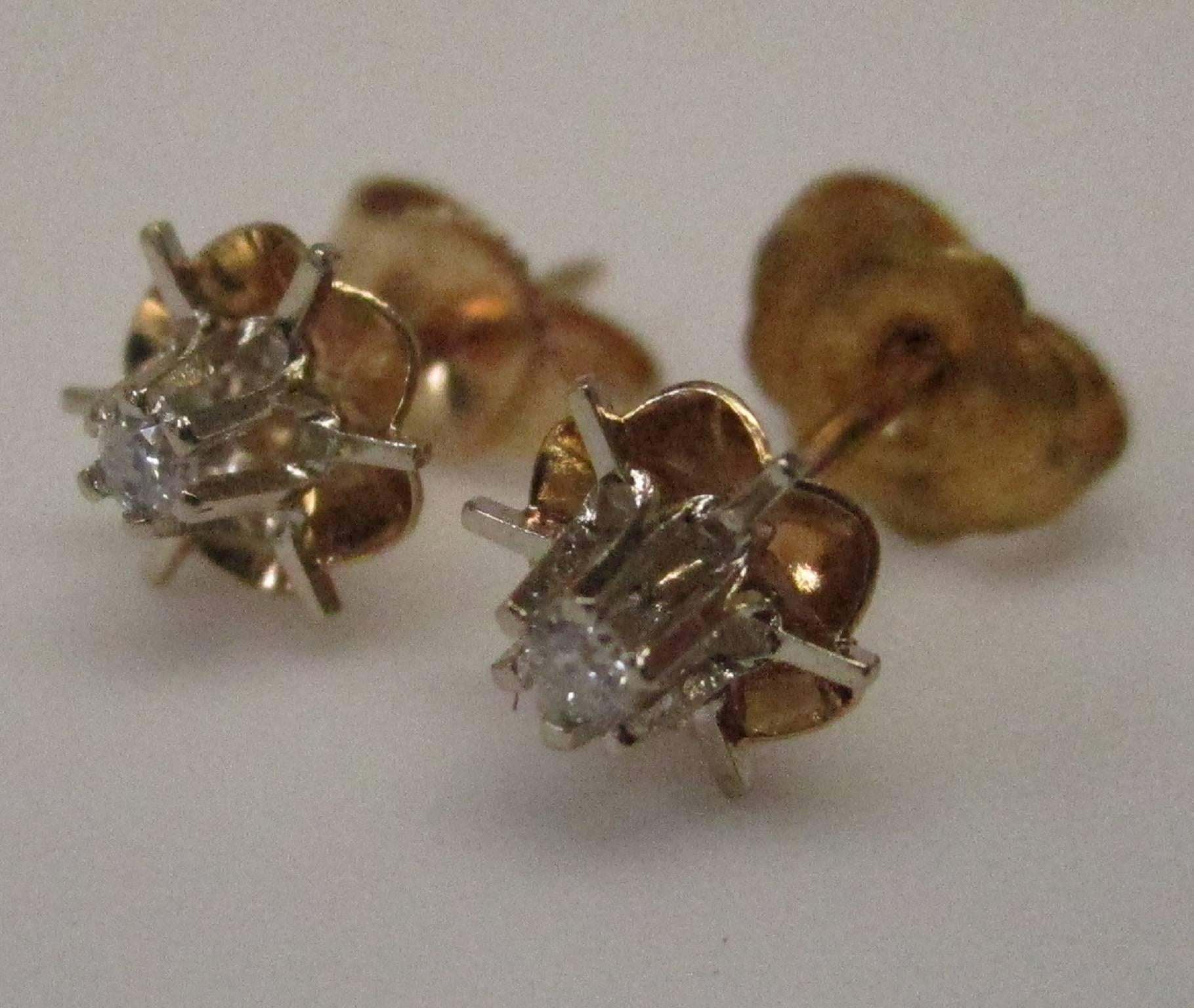 These are precious 14 karat buttercup studs with diamonds, 0.06 carat in total weight, H color, SI clarity. These would make a great everyday pair of earrings, light and easy to wear.

St. John & Myers Jewelry is the only jeweler in Central