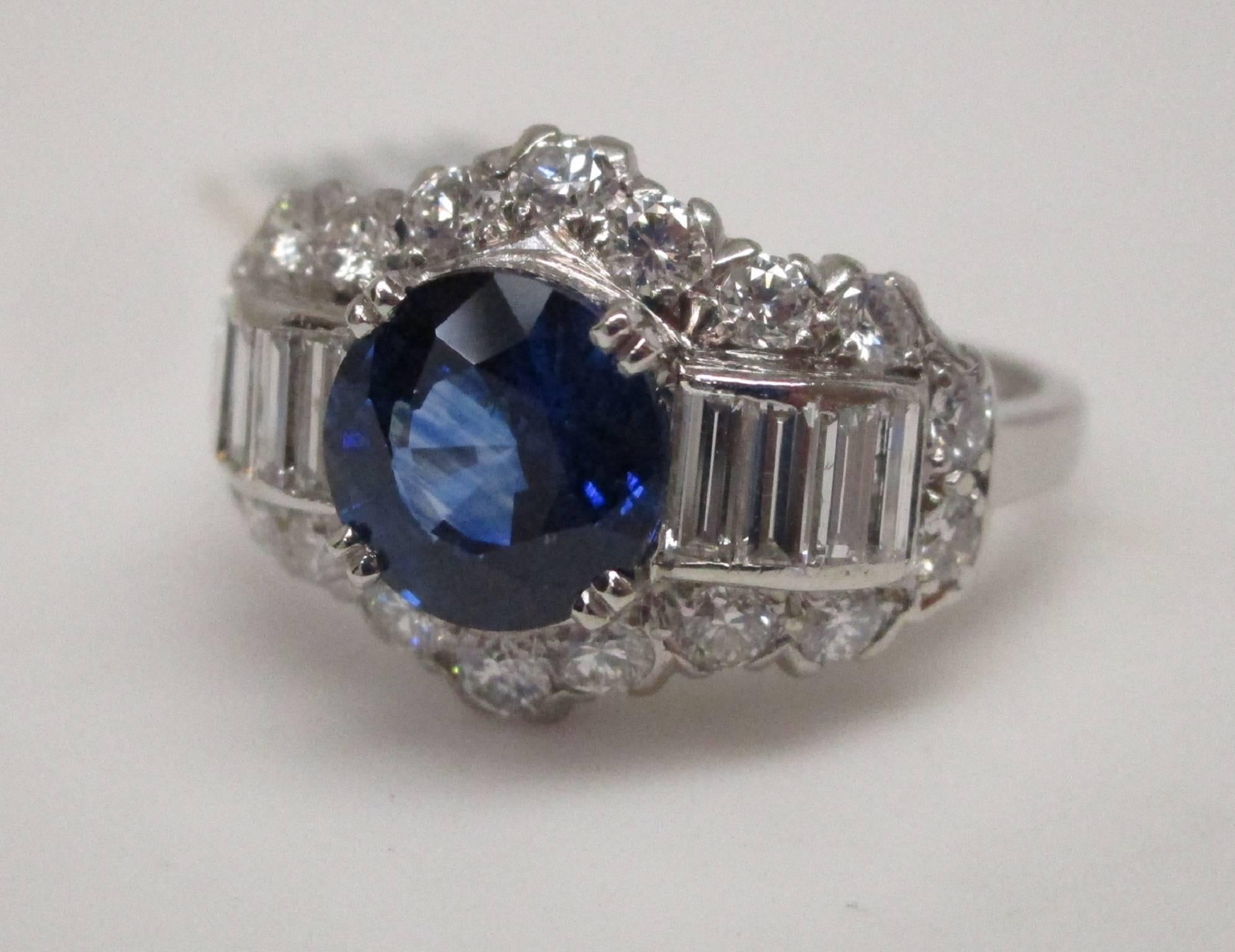 Why have an engagement ring that anyone can have? This is a stunning Platinum engagement ring with a vibrant blue Sapphire in the center and surrounding radiant round and baguette Diamonds. Being a vintage piece, you're not likely to see this ring