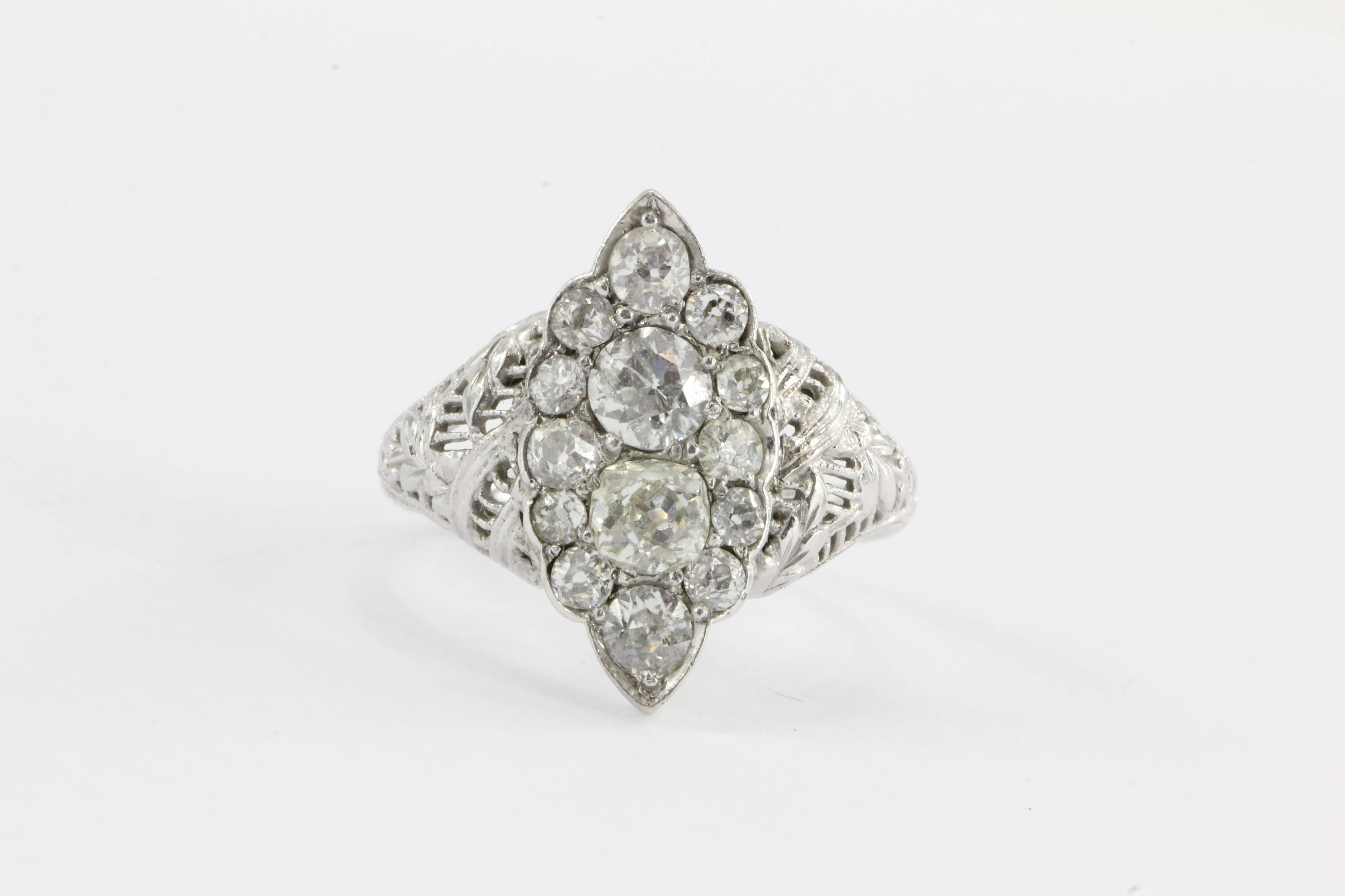 Art Deco 18K White Gold 1.5 CTW Old Mine Cut Diamond Navette Ring. The ring is in excellent estate condition and ready to wear. It is hallmarked 18K HOH. HOH is the makers mark but I am not sure who the maker is. The band design is an intricate
