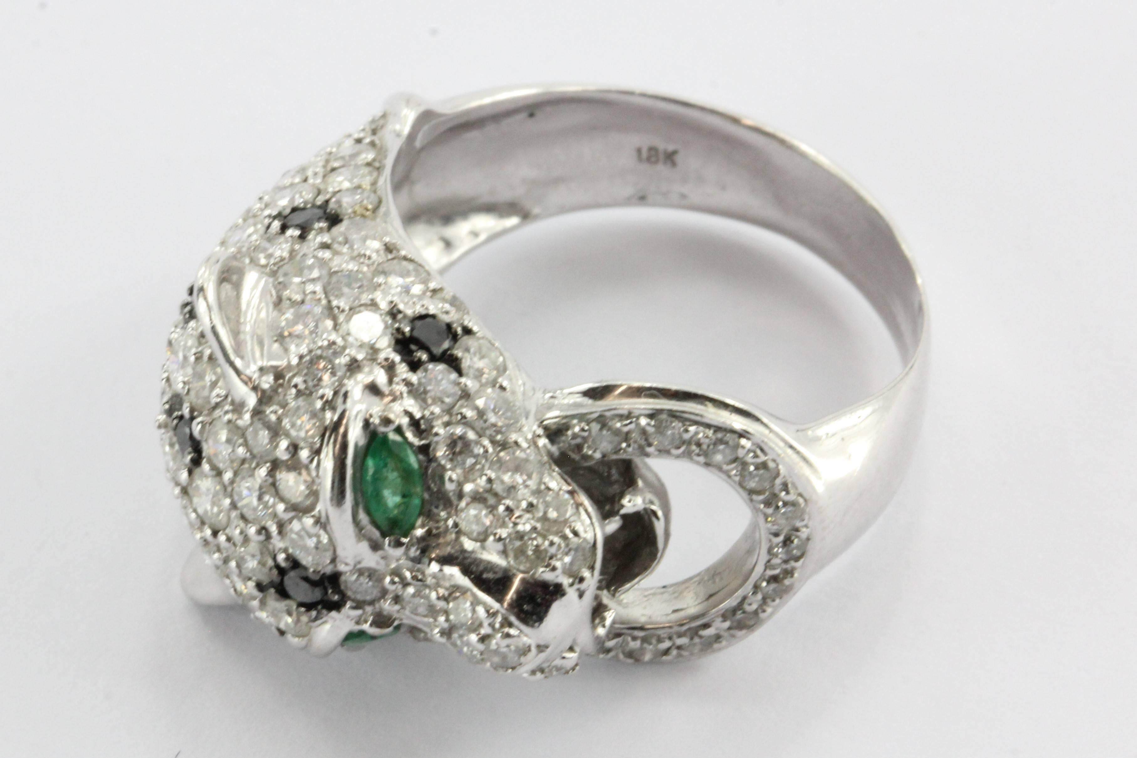18K White Gold Diamond & Emerald Figural Leopard / Jaguar Ring. The piece is in excellent estate condition and ready to wear. It is hallmarked 750 18K. The piece is set with approximately .15 carats of emeralds in the eyes and 1.35 carats of