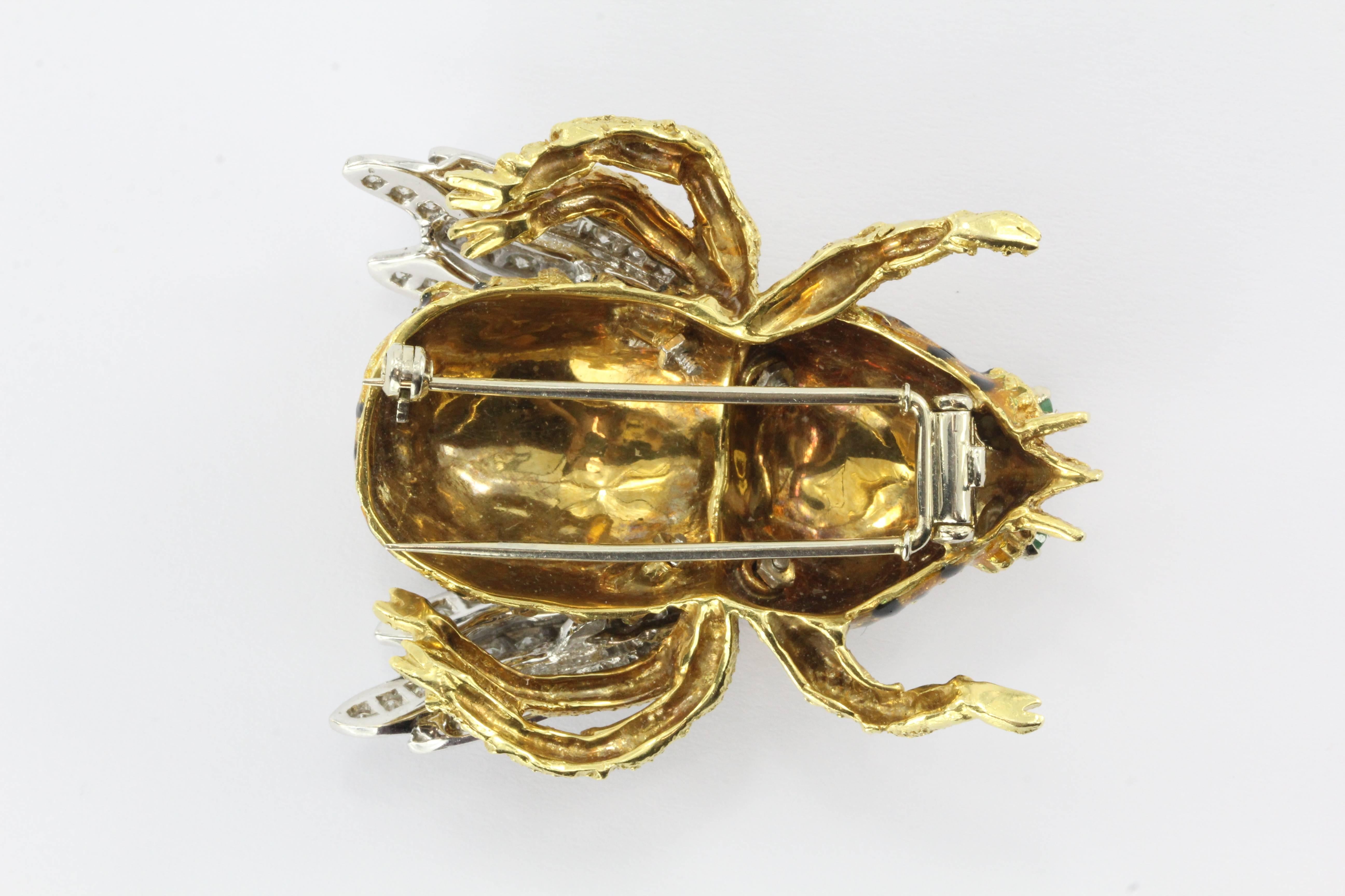 This exquisite bee is sweeter than honey and eager to take up residence on your favorite jacket or coat. 

The honeybee is handcrafted entirely of 18k yellow and white (wings) gold and is stamped with a 750 mark.

Its two emerald eyes add even
