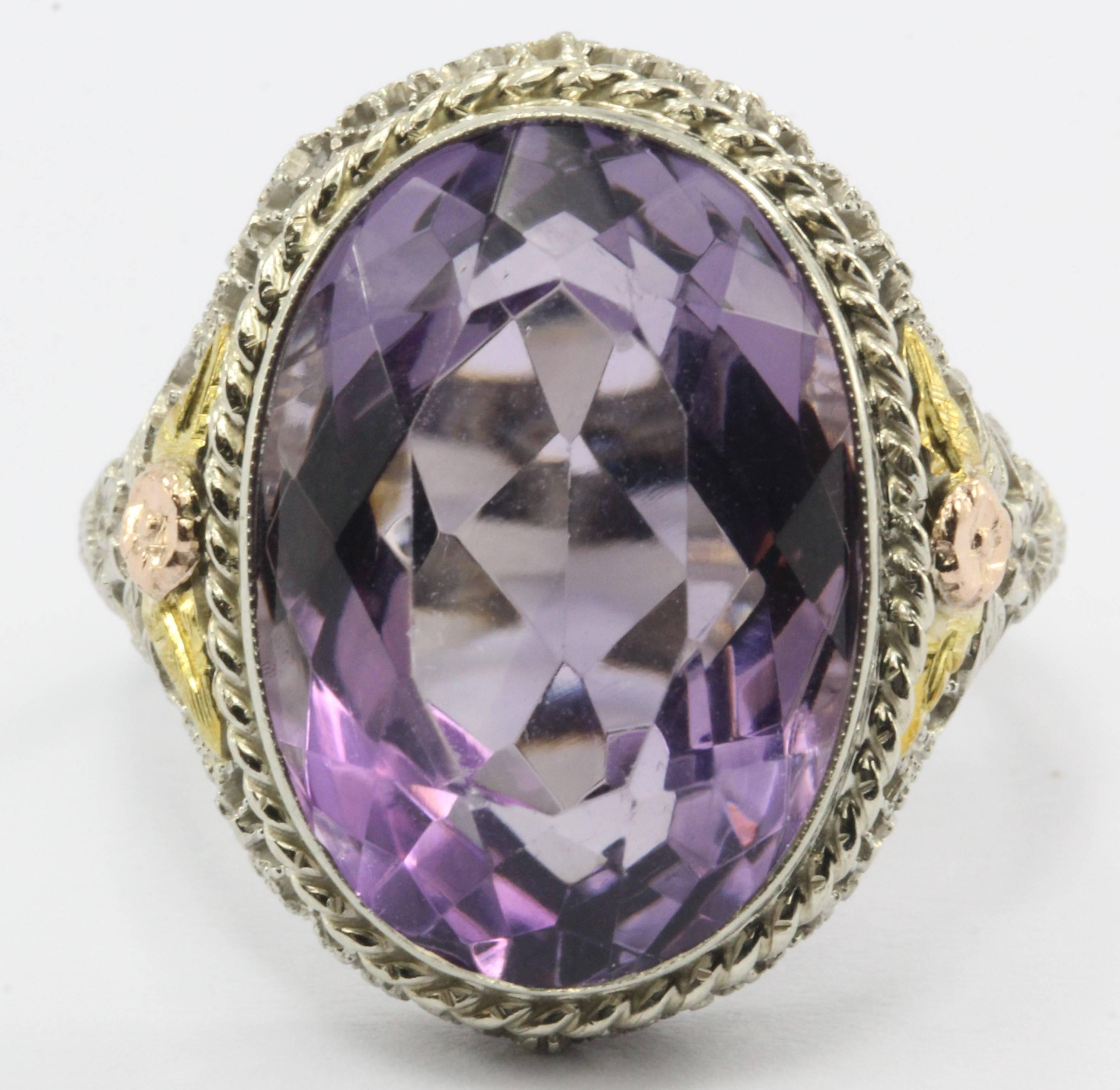 At once both bold and intricate, this impressive amethyst ring is Victorian revival in style and dates from the 1960s.

The large amethyst is approximately 11 carats (18.2mm x 12.85mm x 8.9mm) and is set in a 14k white gold filigree setting.

A
