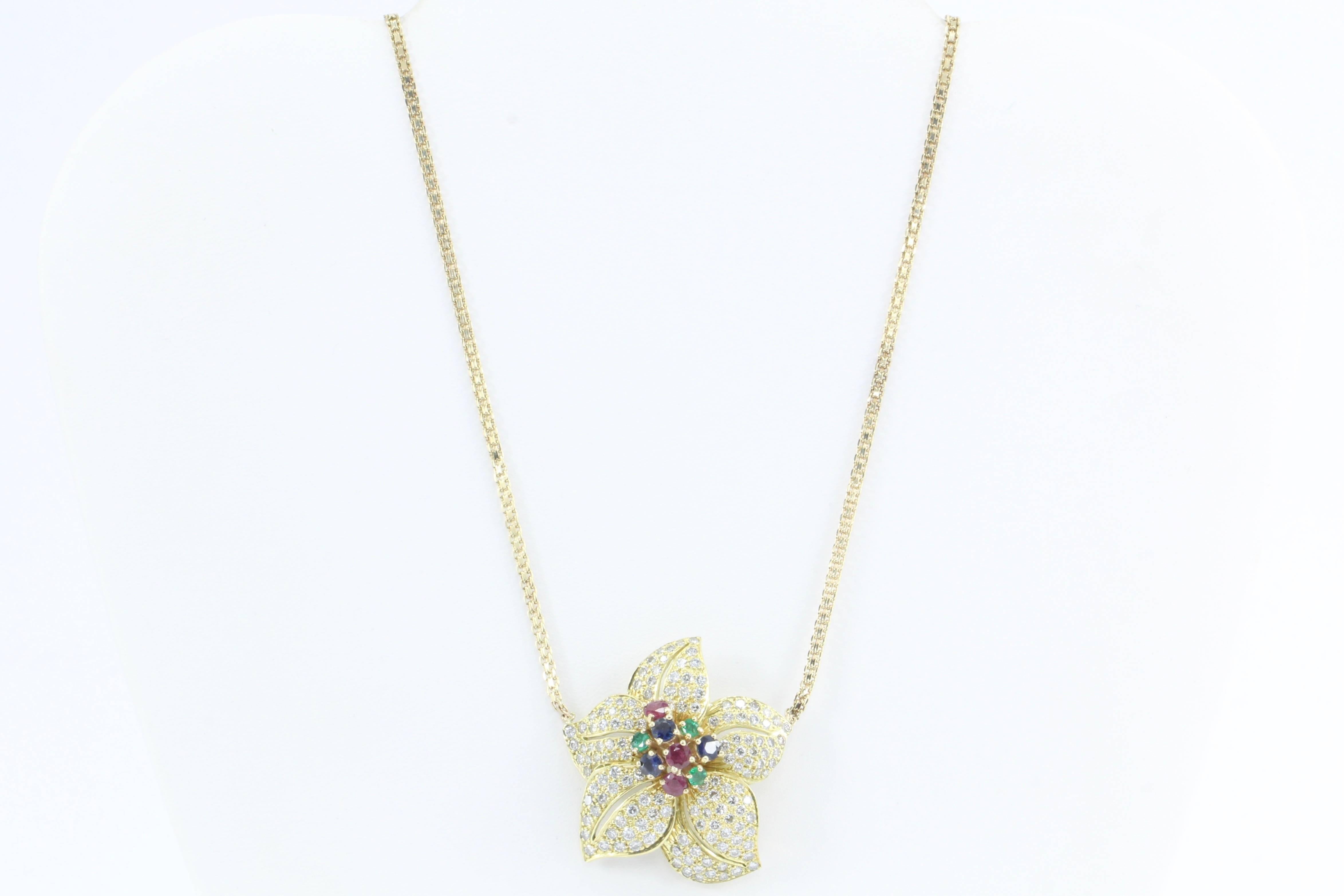 Retro Gold Diamond Emerald Ruby Sapphire Chunky Flower Necklace

Luxurious large tropical flower petals studded in diamonds frame a cluster of natural rubies, emeralds, and sapphires. The flower is 18K yellow gold and the chain is 14k yellow gold.