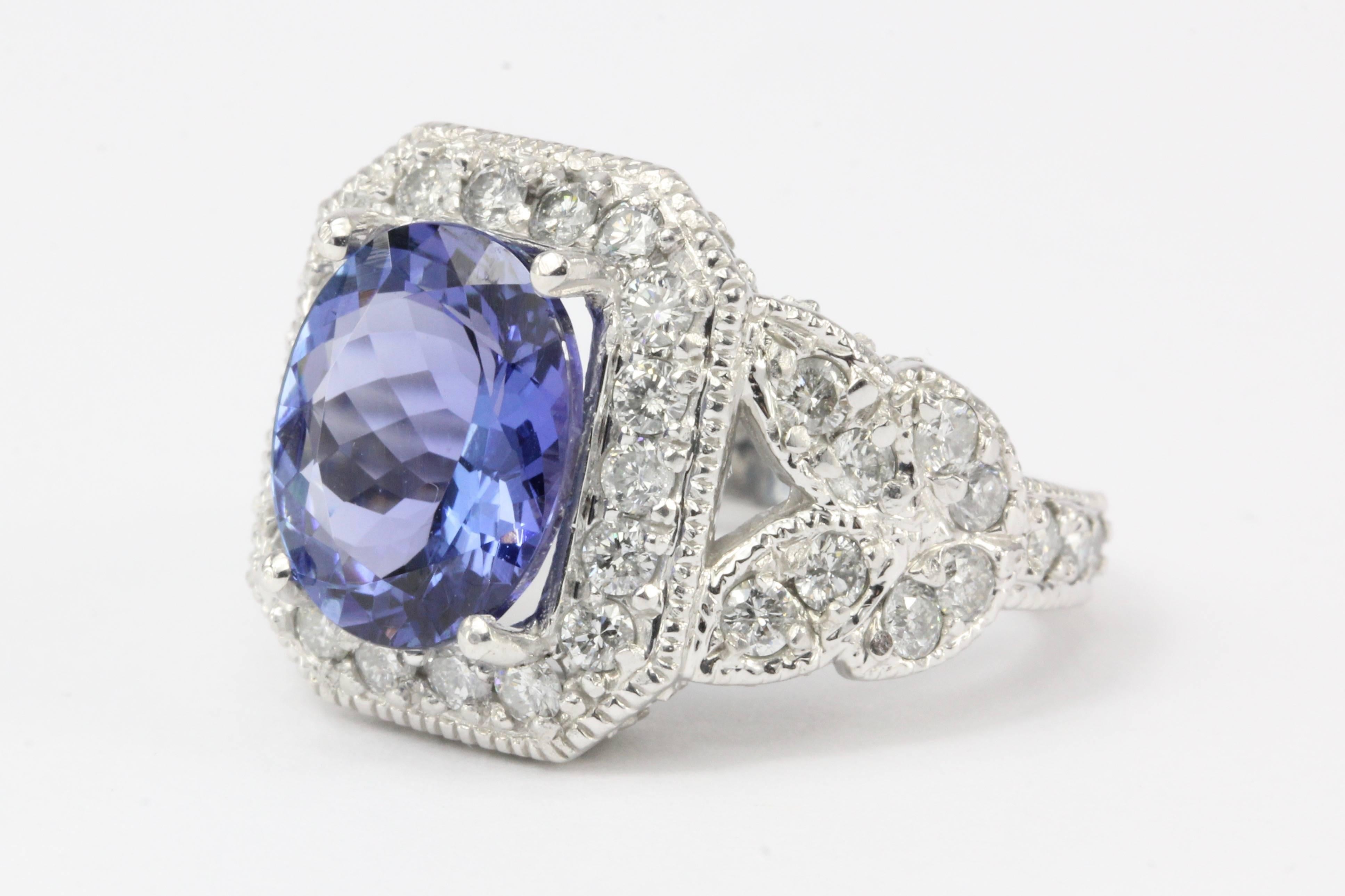 Era: Modern 

Composition: 14K white gold

Primary Stone: Tanzanite

Stone Carat: 5 Carat

Secondary Stone: Diamond

Secondary Stone Carat Weight: 2.5 CTW

Color: H/I

Clarity: Si2/I1

Ring Face: 17mm x 15mm wide

Ring Size: 6

Ring Weight: 12.4
