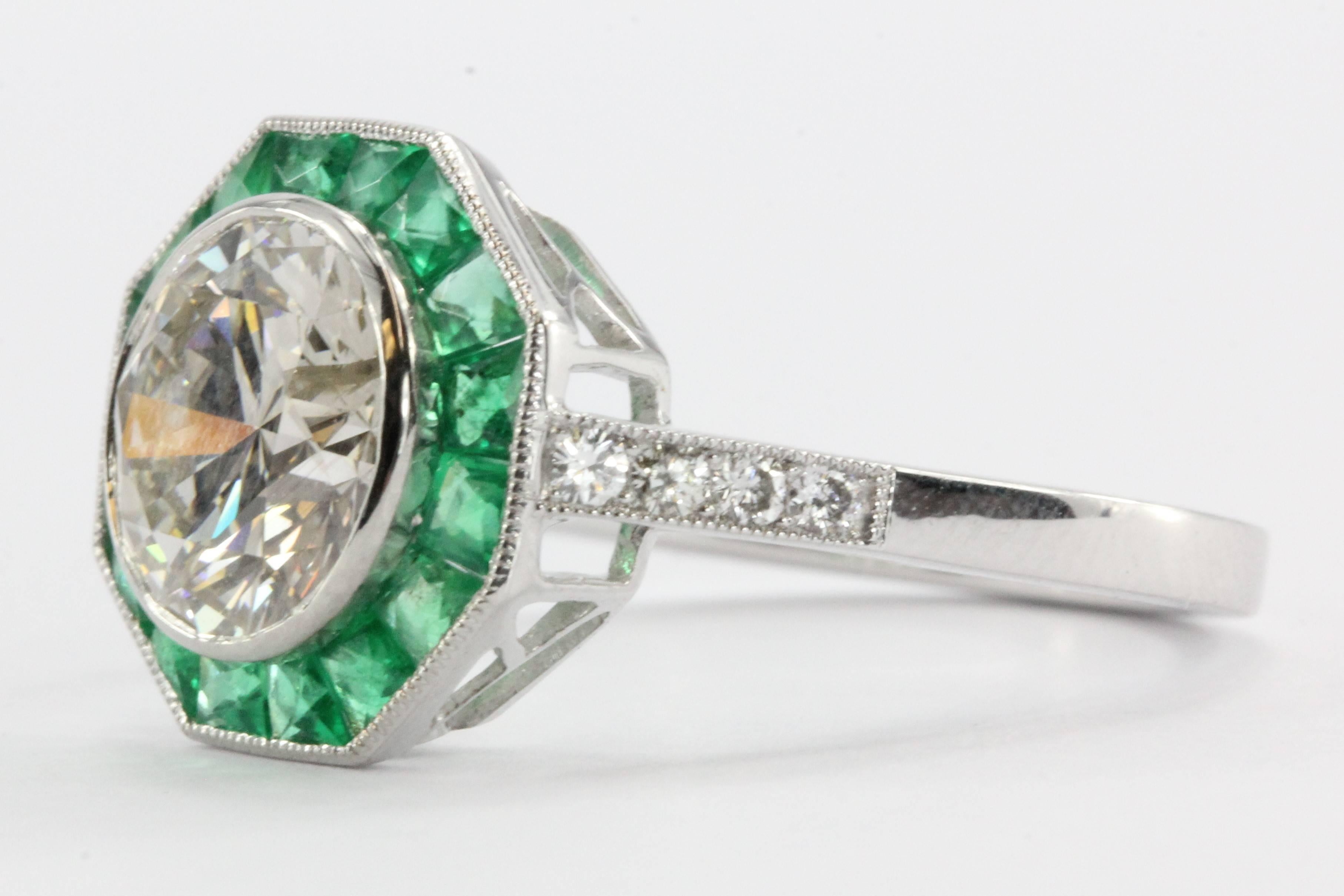 Art Deco style, vintage inspired platinum set diamond and emerald engagement ring by Sophia D. The is new and has never been worn before. The center stone is a approximately 2.1 carats and conservative L color  and Si2 clarity. It is framed with a