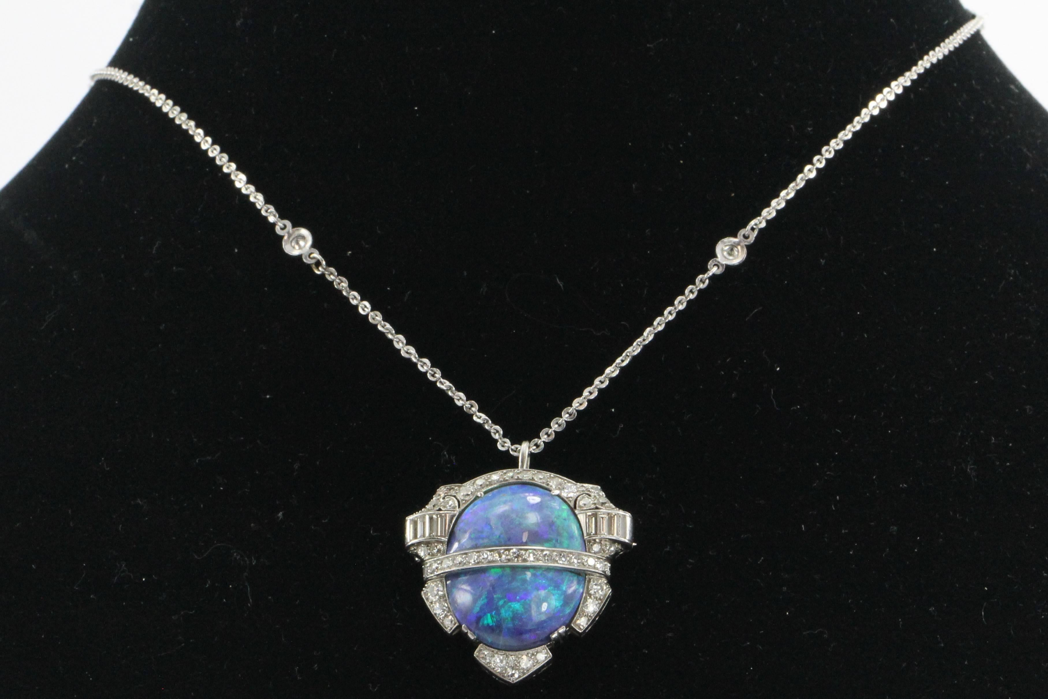 The bklaopal is actually two 7.5 carat opals totaling 15 carats.  The opals are set in platinum and framed by 2 carats of D / E color, Vvs1 / Vvs2 clarity single cut and baguette diamonds. The piece can be worn as a brooch or pendant. The bezel that